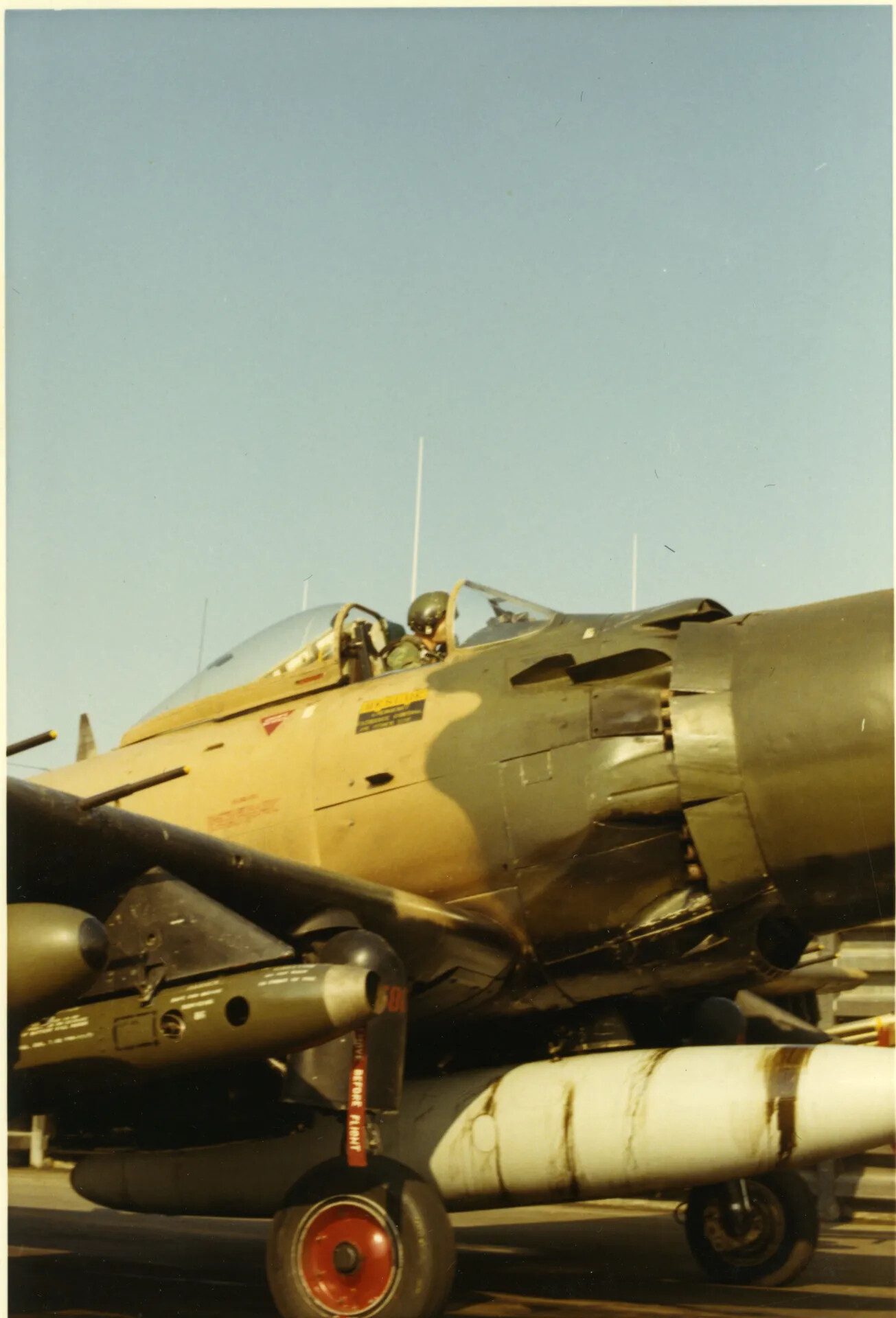 A-1 Skyraider Pilot in Cockpit, Close-Up Detail of Camouflage and Ordnance