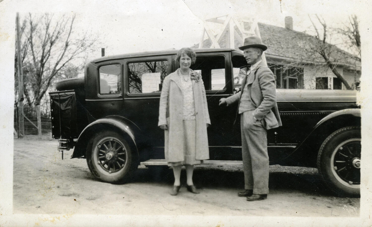 Couple Posing with Automobile Outside Residence, Late 1920s