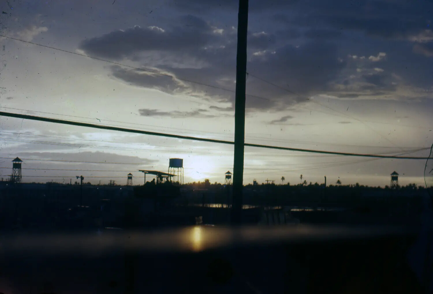Sunset Silhouette of Perimeter Guard Towers and Water Tower, Vietnam War-Era Base