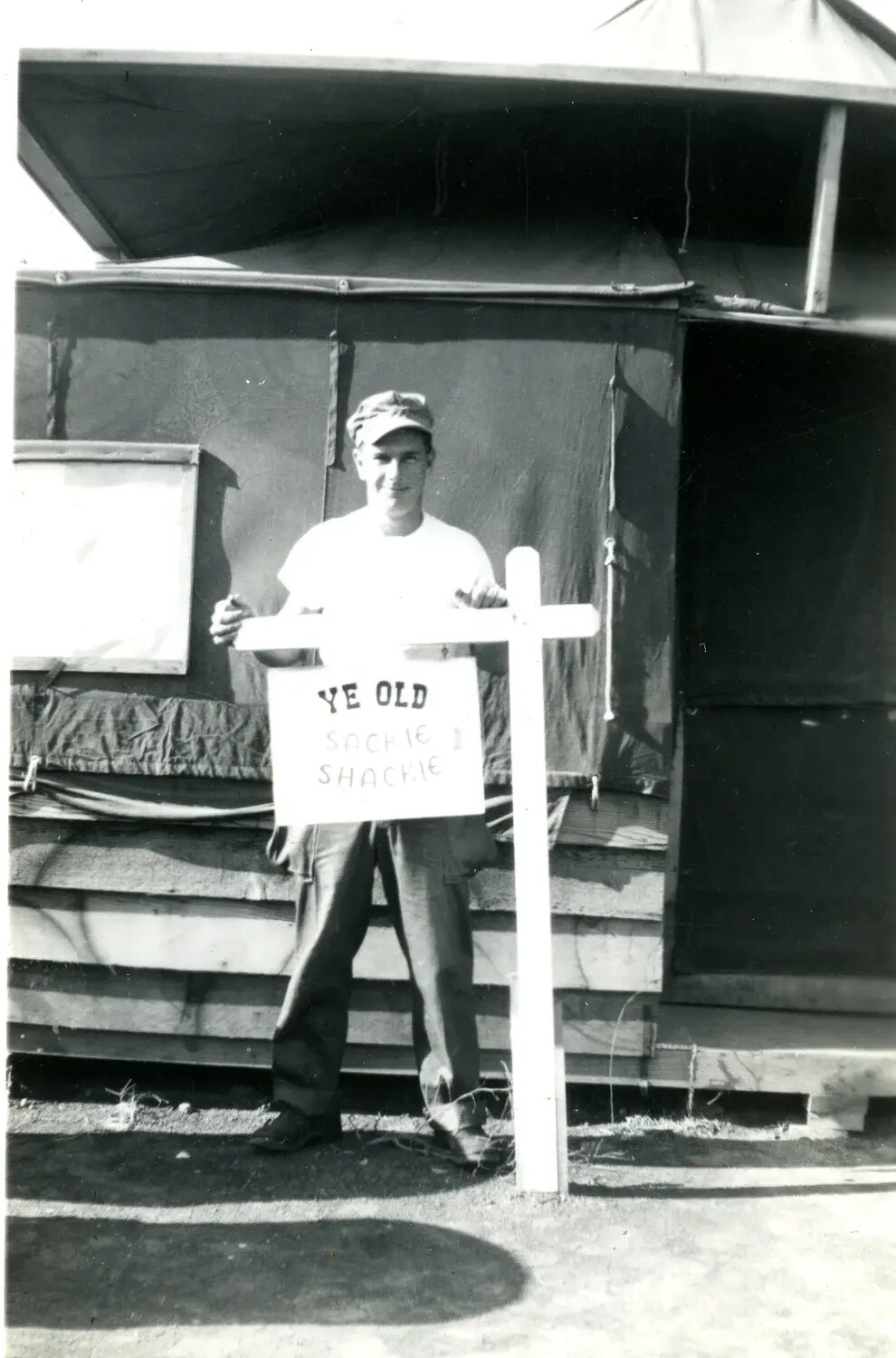 Marine Beside Hand-Lettered 'Ye Old Sackie Shackie' Sign, Tent Camp, WWII