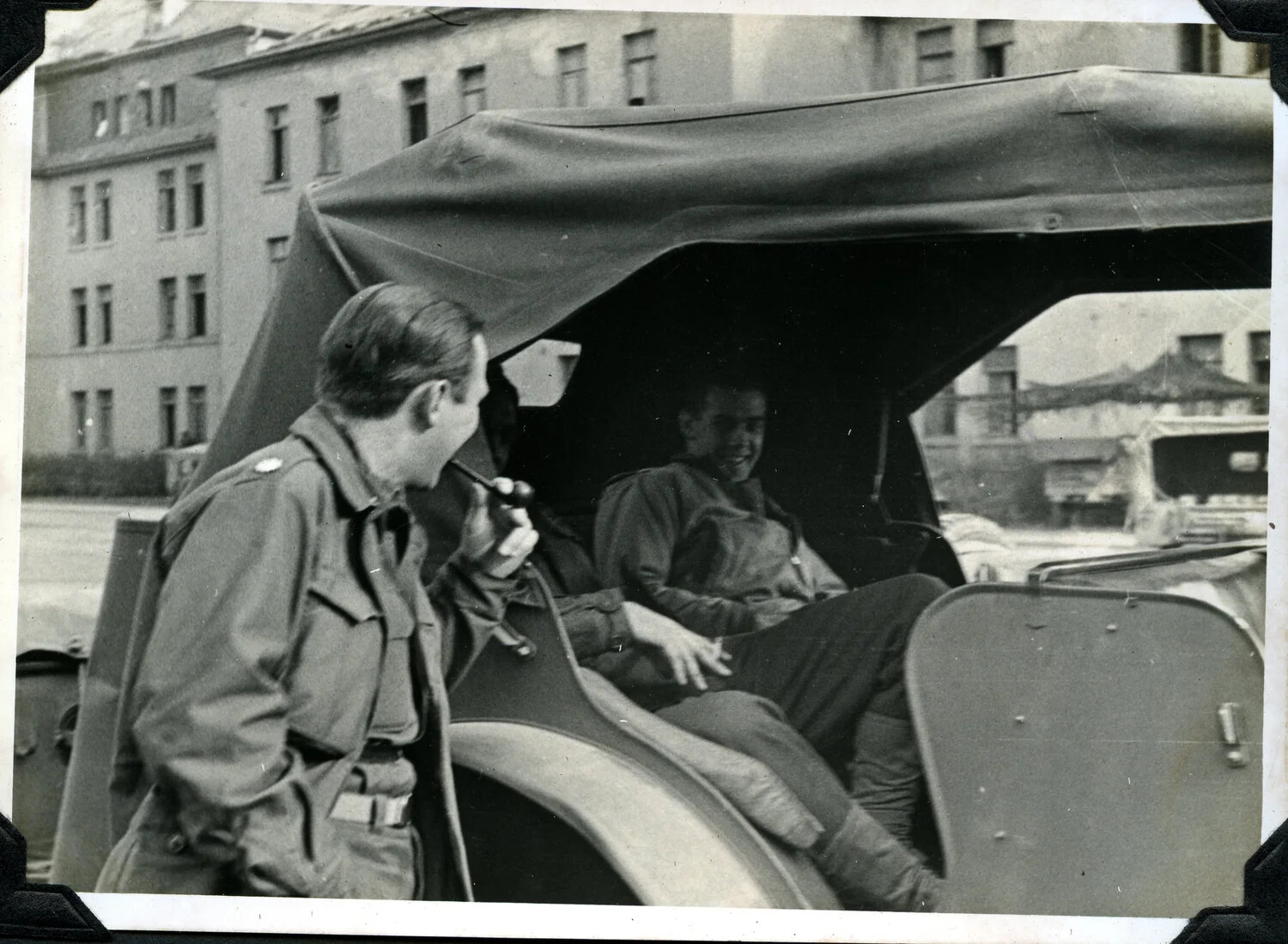 Two U.S. Army Soldiers at Canvas-Topped Military Vehicle, European Street Scene, WWII Era