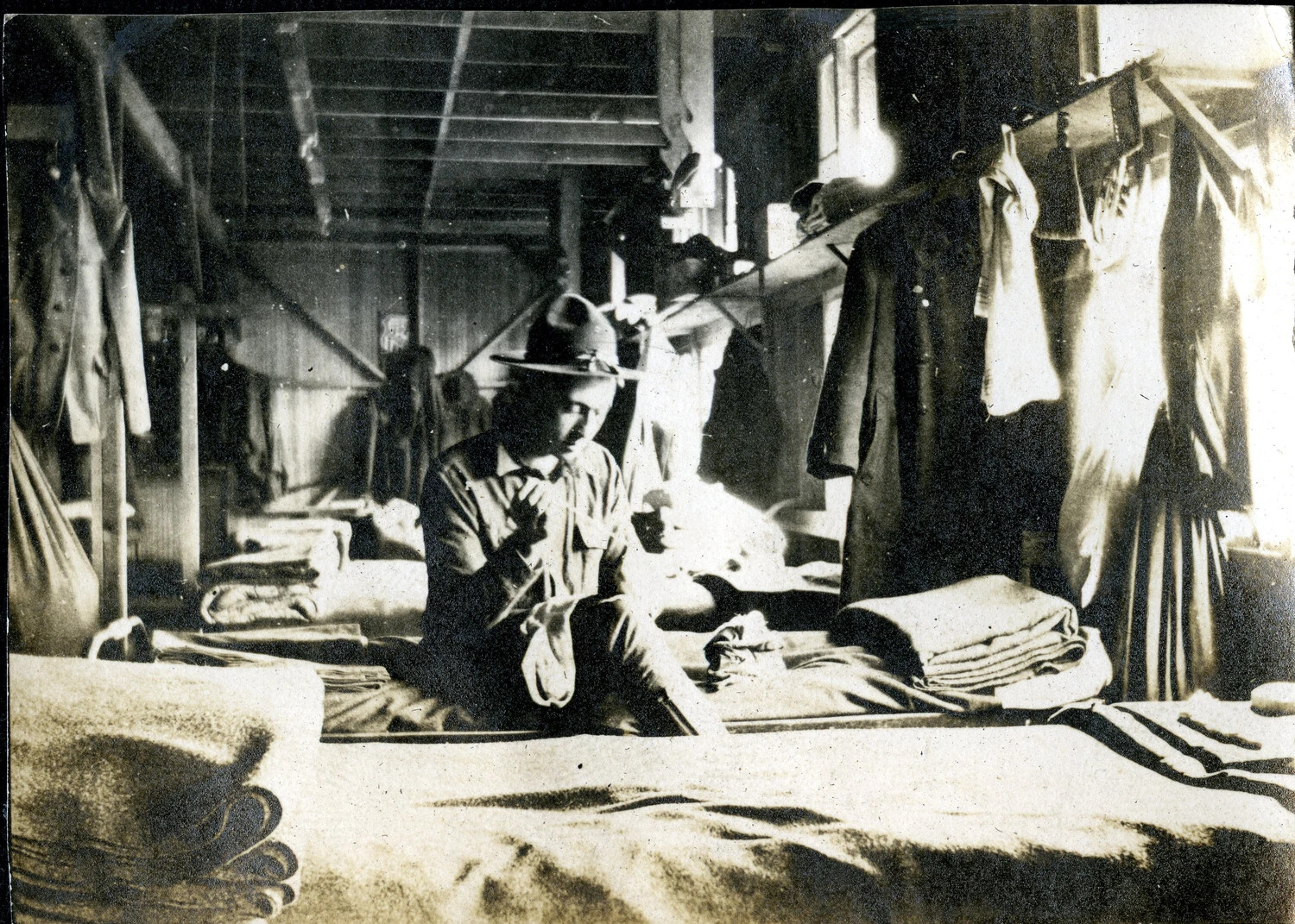 Soldier Mending Clothing in Barracks, 'Learning How,' WWI Era