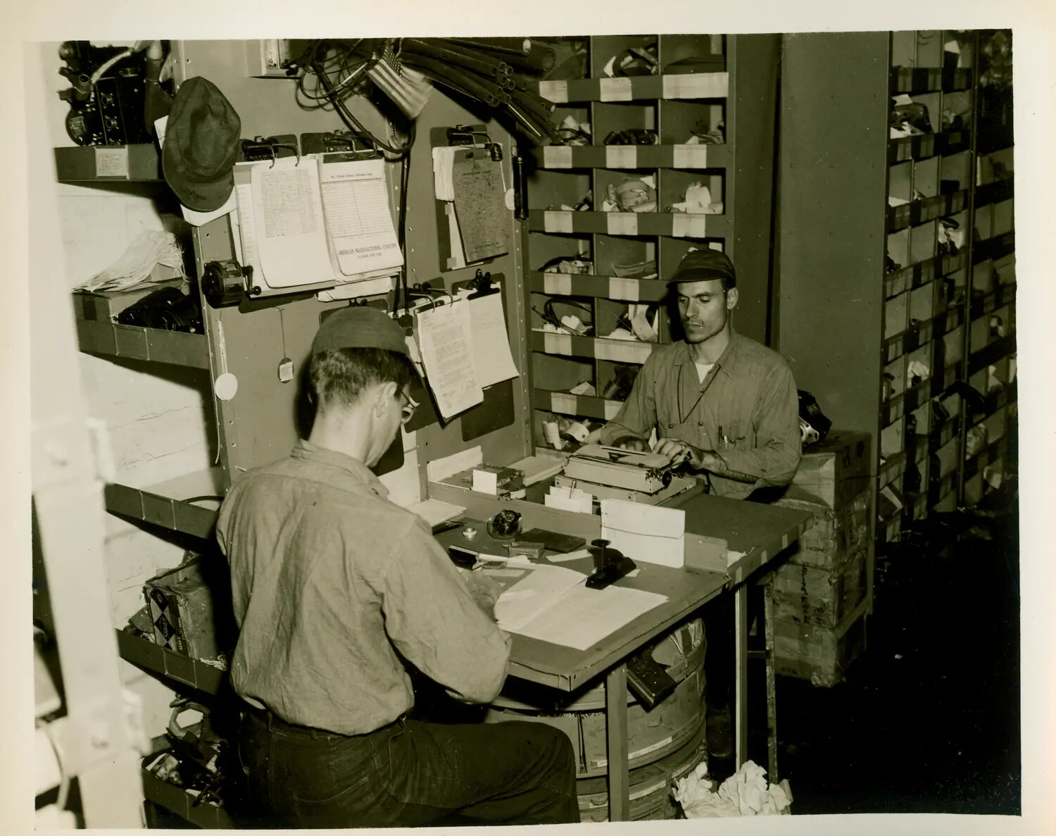 Sailors at Work in Parts and Supply Compartment, USS Petrof Bay (CVE-80)