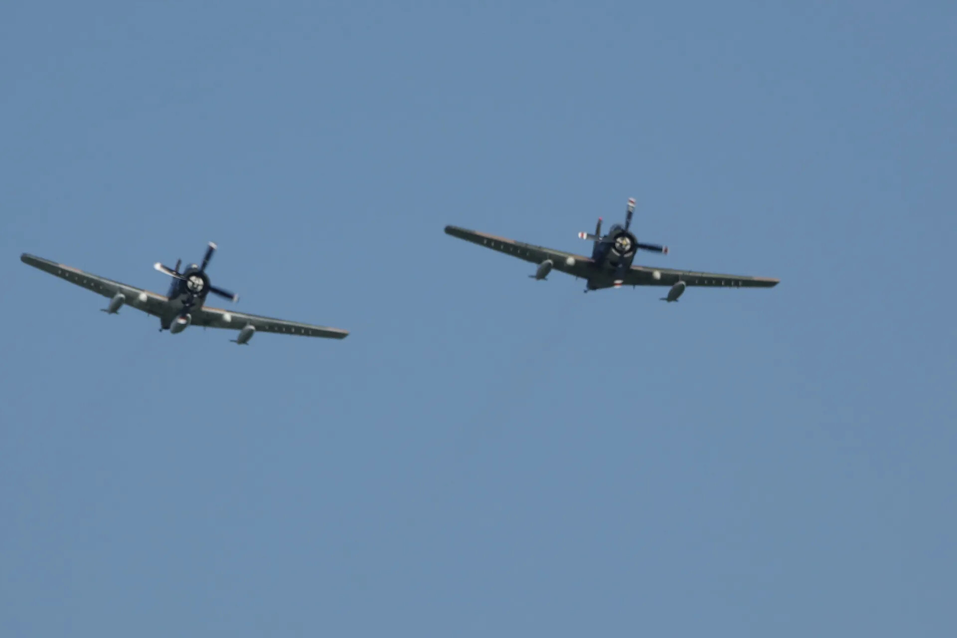 Formation Flight of Two A-1 Skyraiders Against Clear Blue Sky