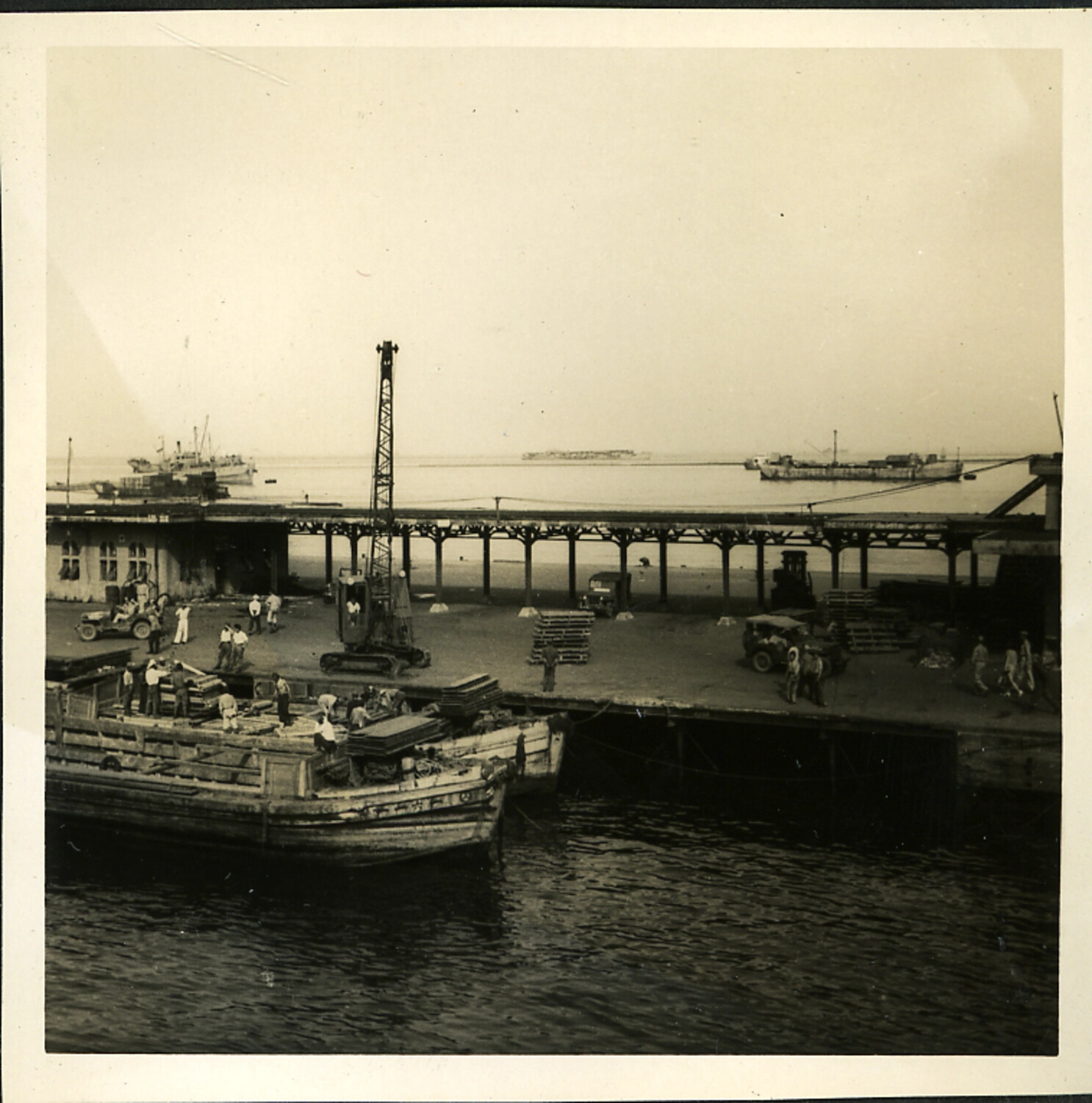 Harbor Wharf with Cargo Barge, Crane, and Dockworkers, Occupied Japan