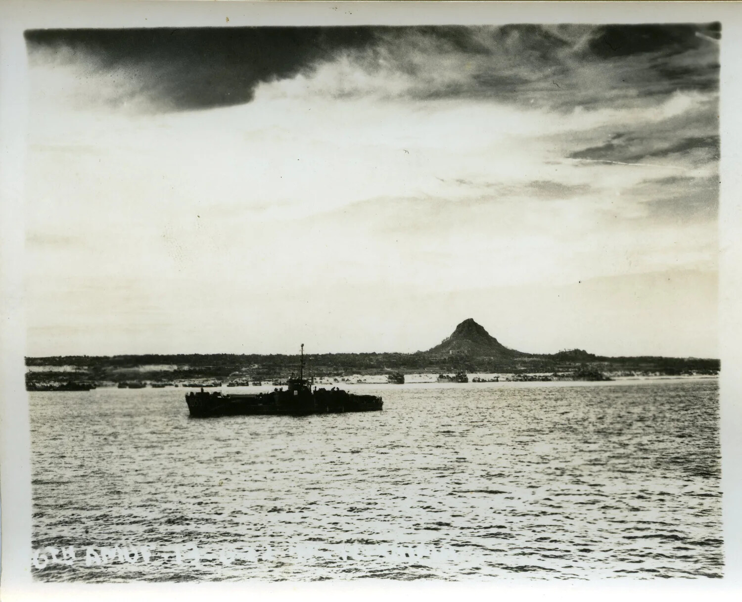 Landing Craft Off Ie Shima with Iegusuku Peak ("The Pinnacle") in Background, Ryukyu Islands, 1945
