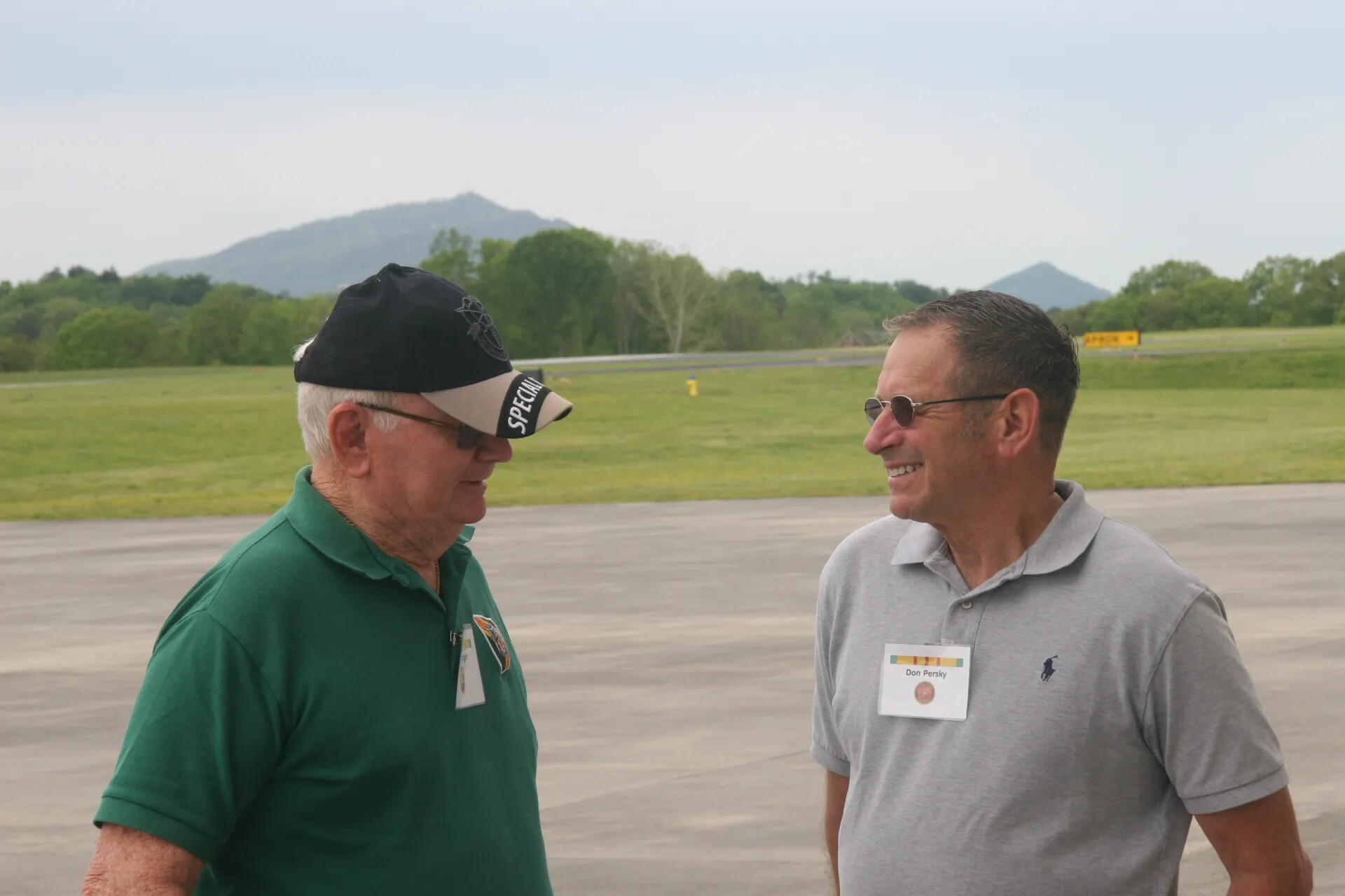 Veterans Don Persky and Companion Conversing on Airport Apron During Operation Tailwind Reunion