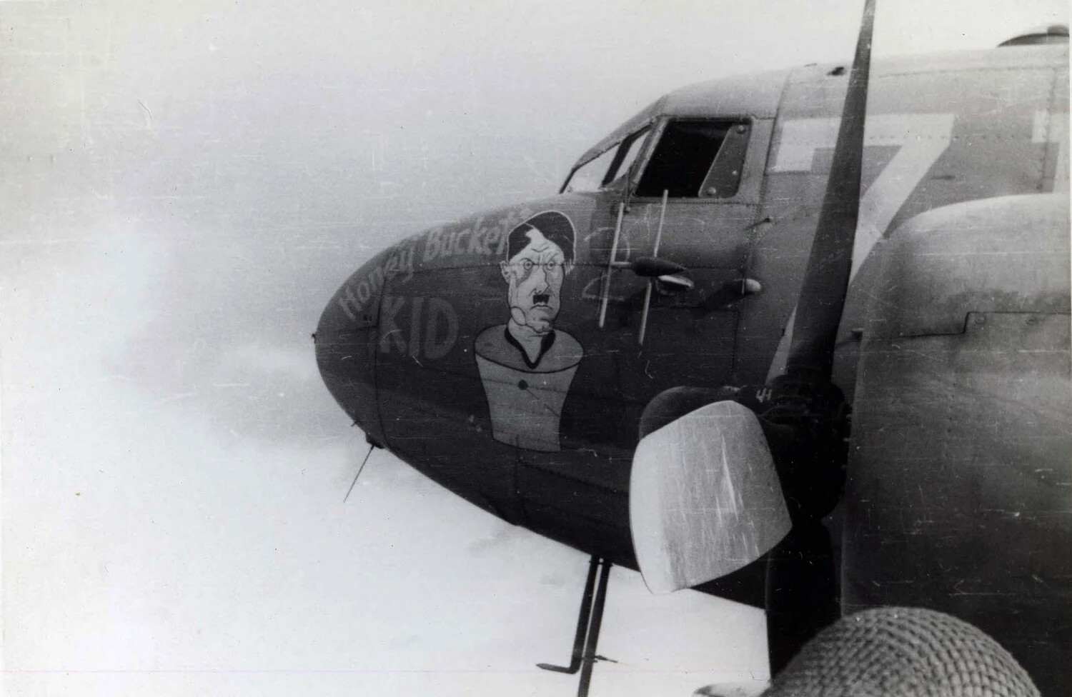 Nose Art 'Honey Bucket Kid' Depicting a Caricatured Hitler on a C-47 Skytrain, WWII