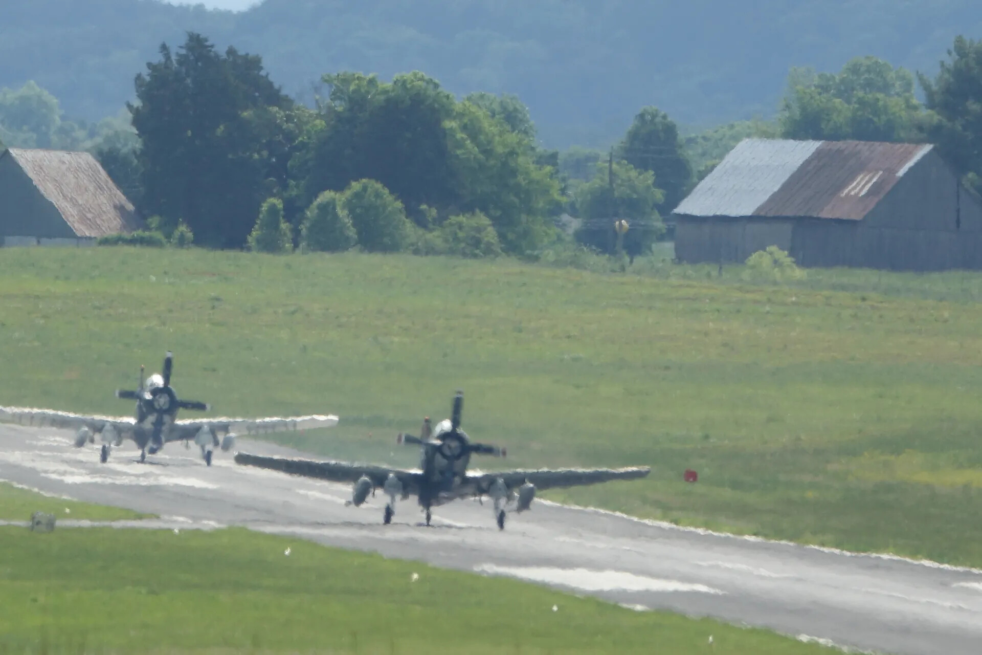 Pair of Douglas A-1 Skyraiders Taxiing at Rural Airstrip Fly-In, May 2019