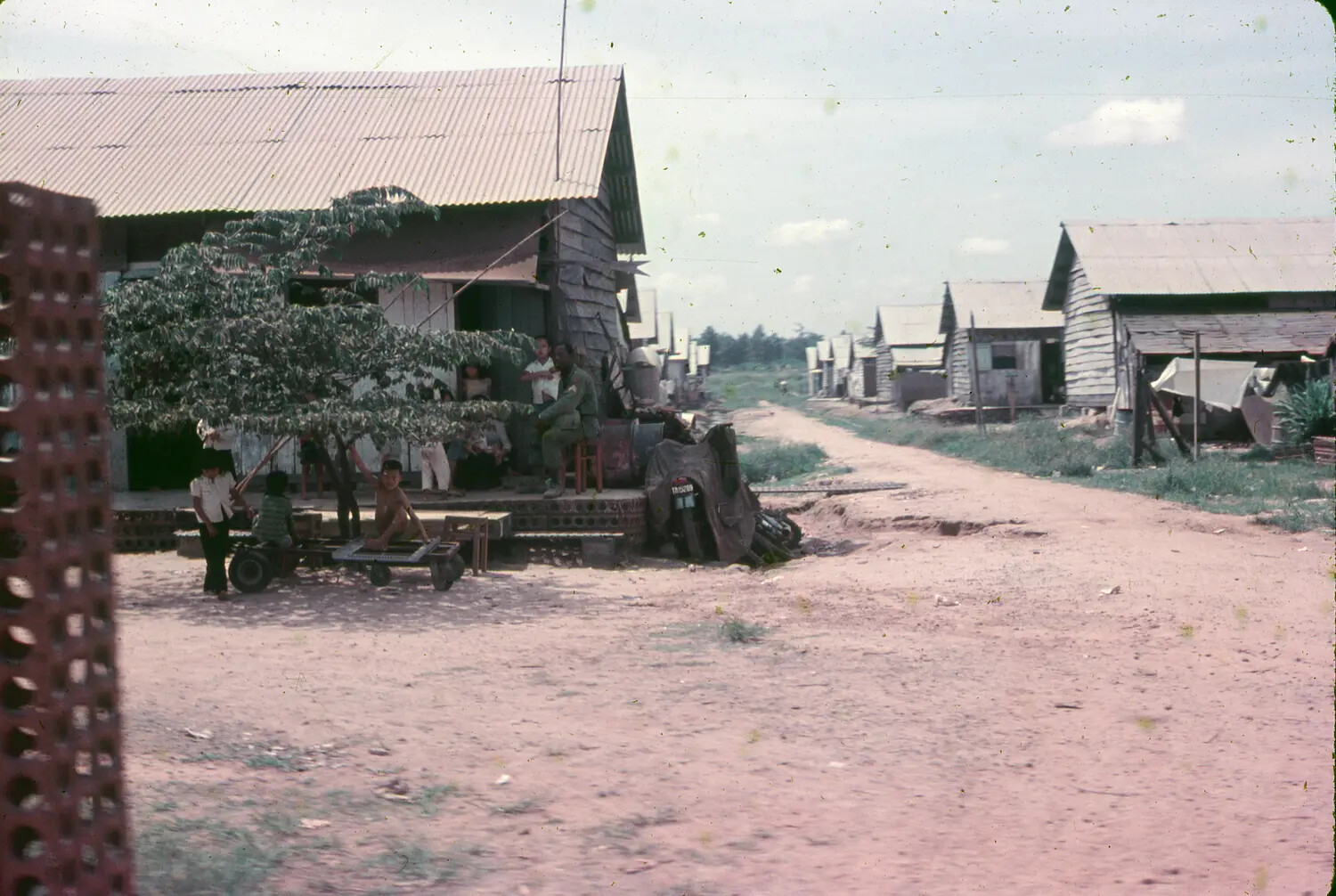 American Serviceman and Vietnamese Villagers Along a Dirt Road, Vietnam, 1965