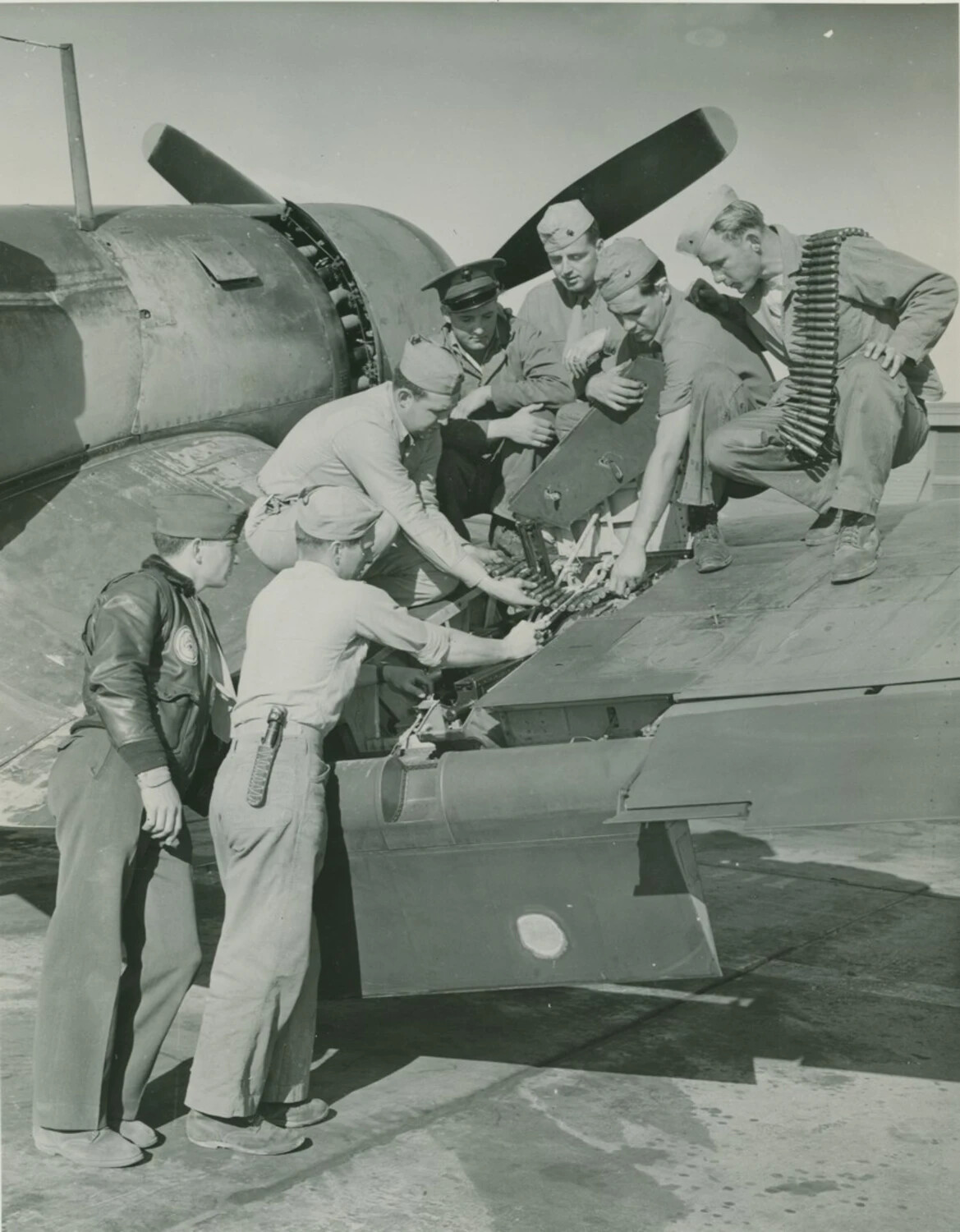Ground Crew Loading Machine Gun Ammunition into Fighter Aircraft Wing, McAleer Collection