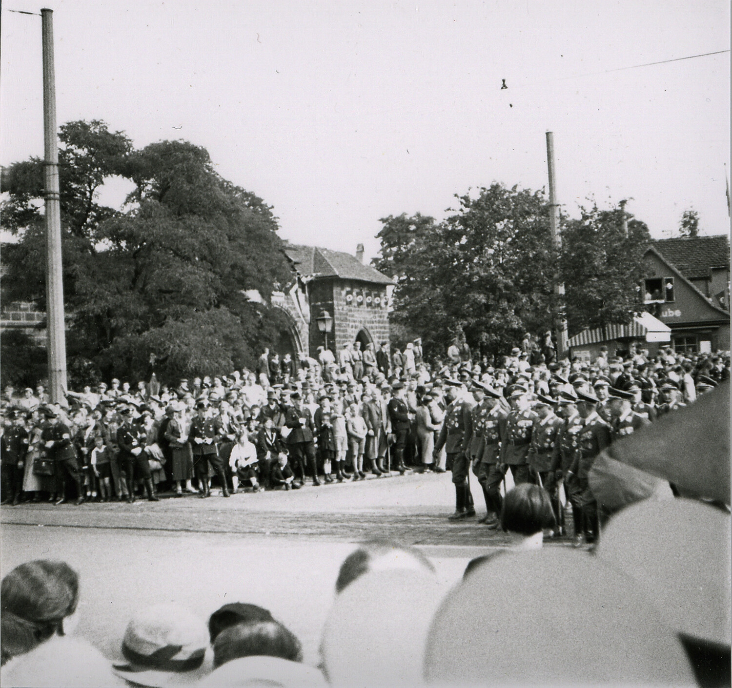 Uniformed Marchers and Crowd Before Historic Gate Tower, Nuremberg, Germany