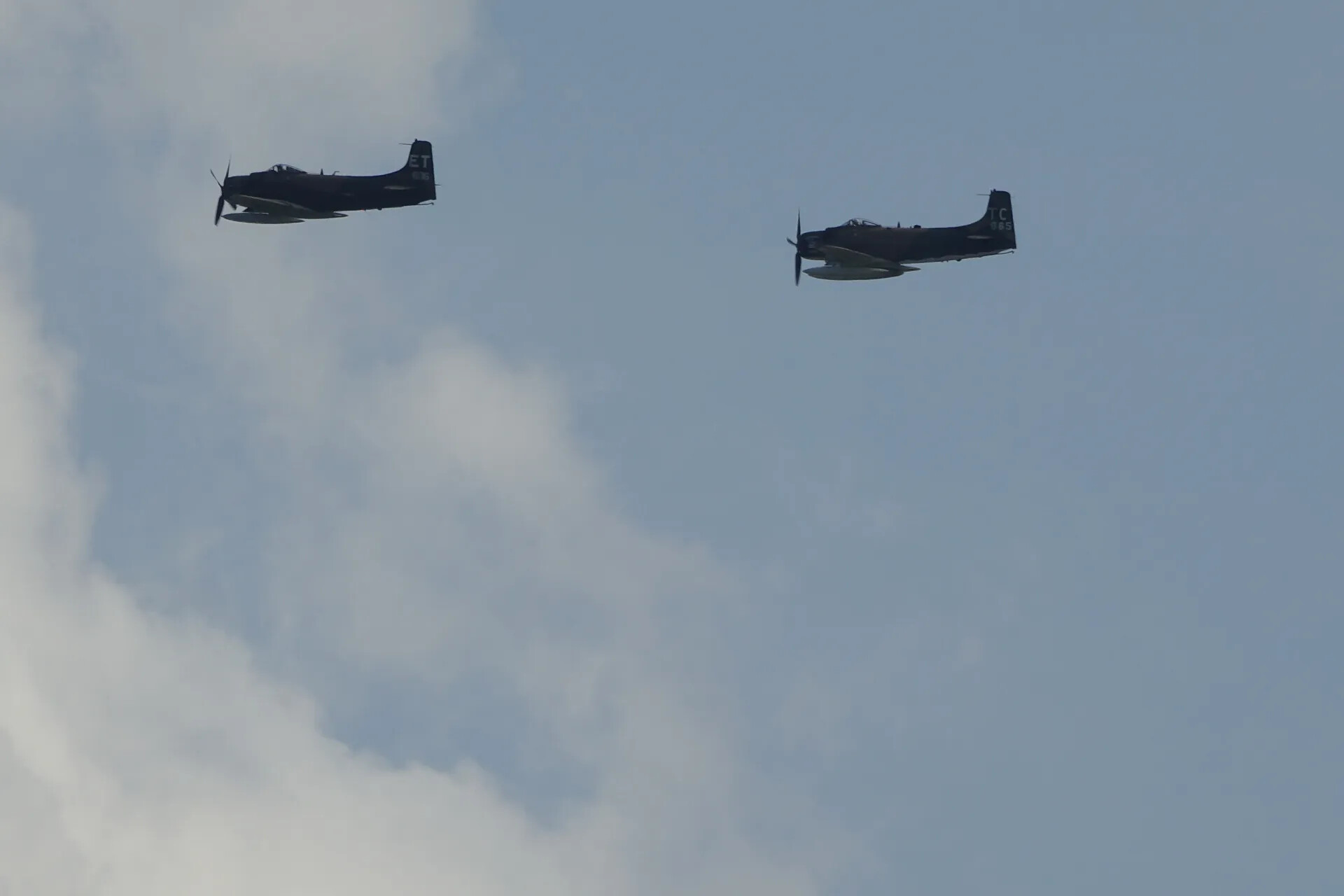 Two A-1 Skyraiders in Formation Flight, Partly Cloudy Sky