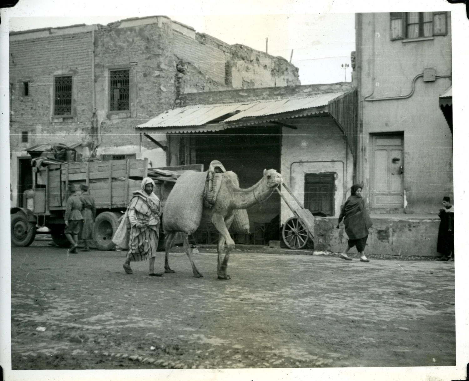 Camel Caravan and U.S. Army Truck in North African Street Scene, WWII Signal Corps Photograph