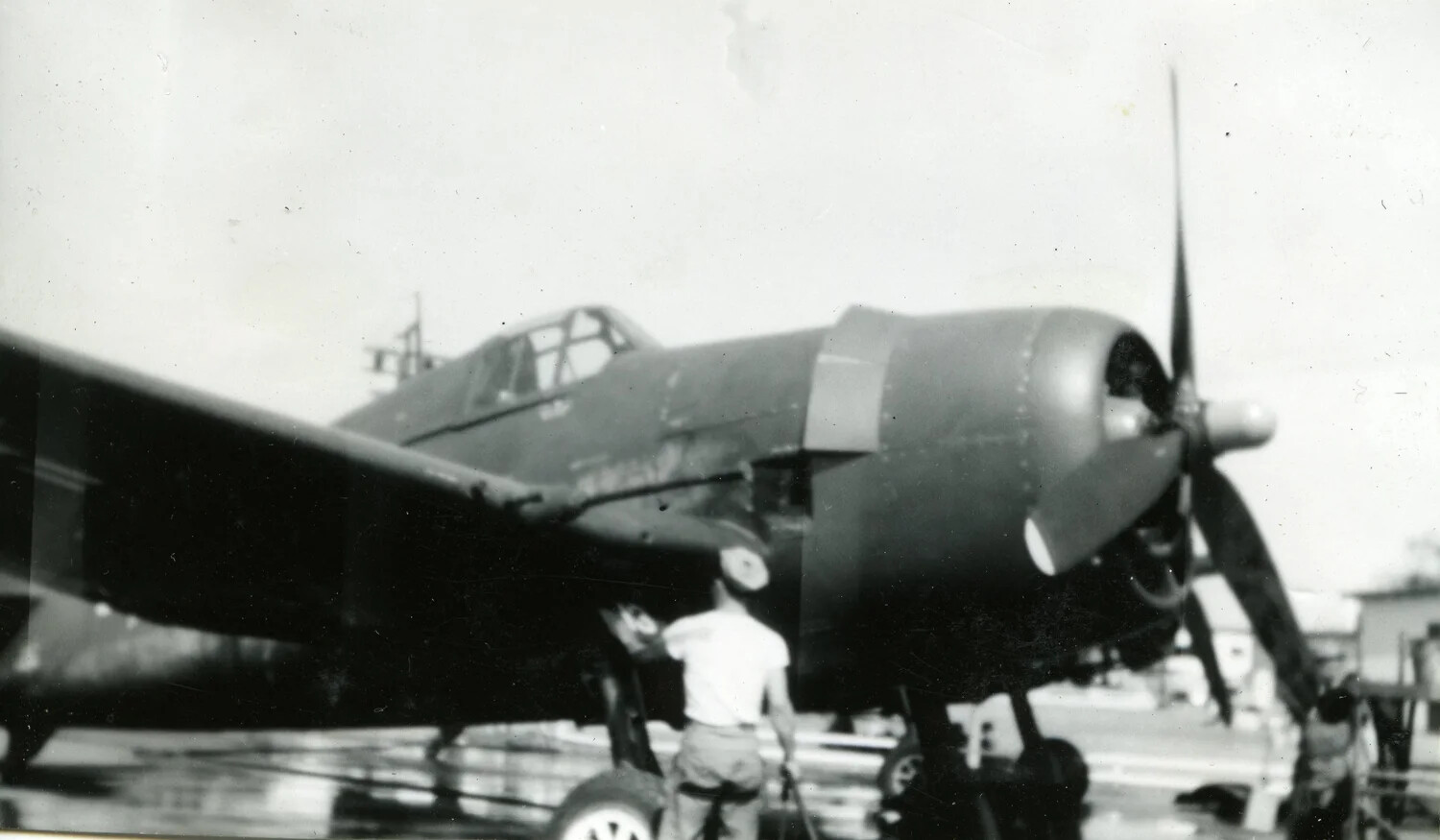 Ground Crewman Servicing an F4U Corsair Fighter, VMF-214, 1945