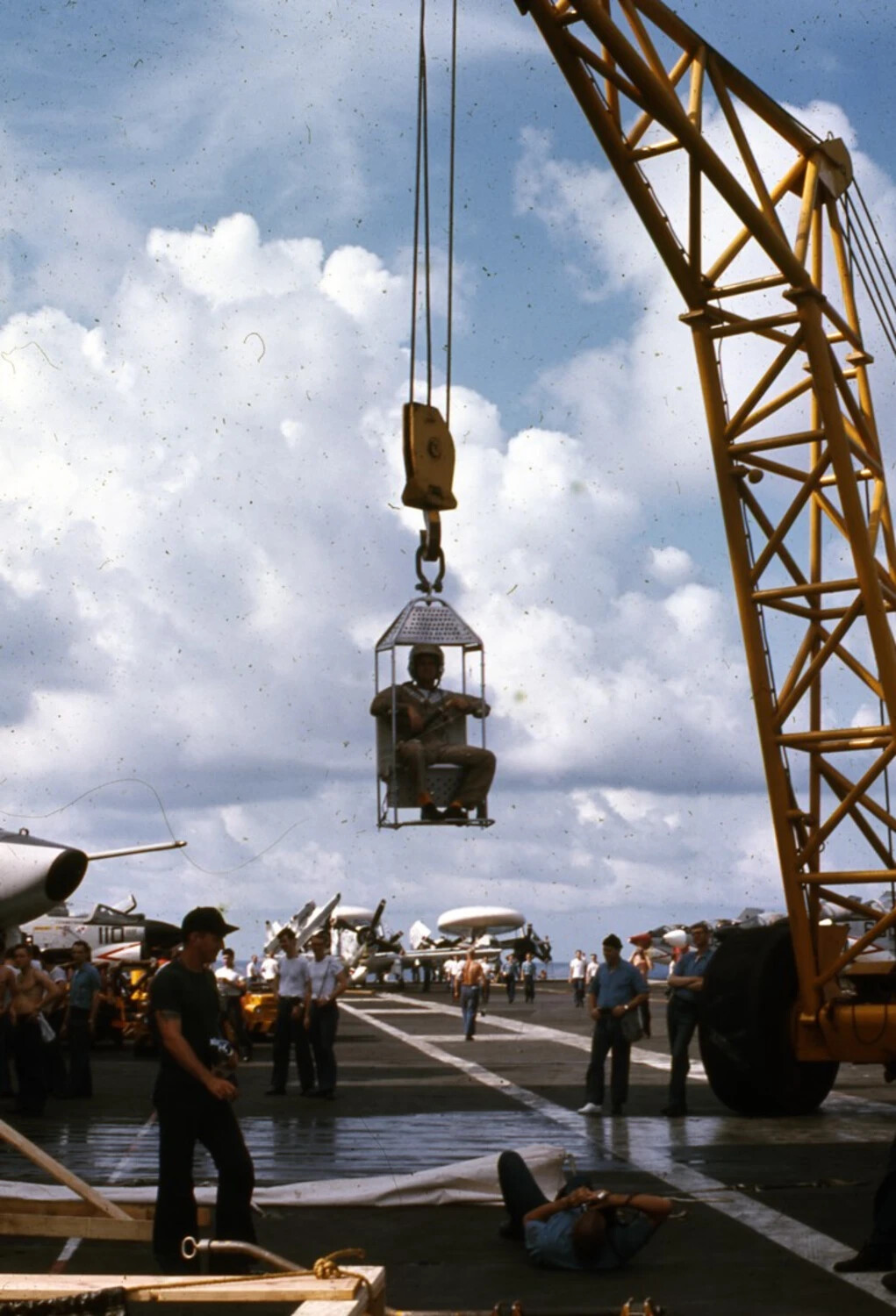 Sailor Hoisted in Safety Cage by Mobile Crane on Carrier Flight Deck, USS Ticonderoga, Vietnam War Era