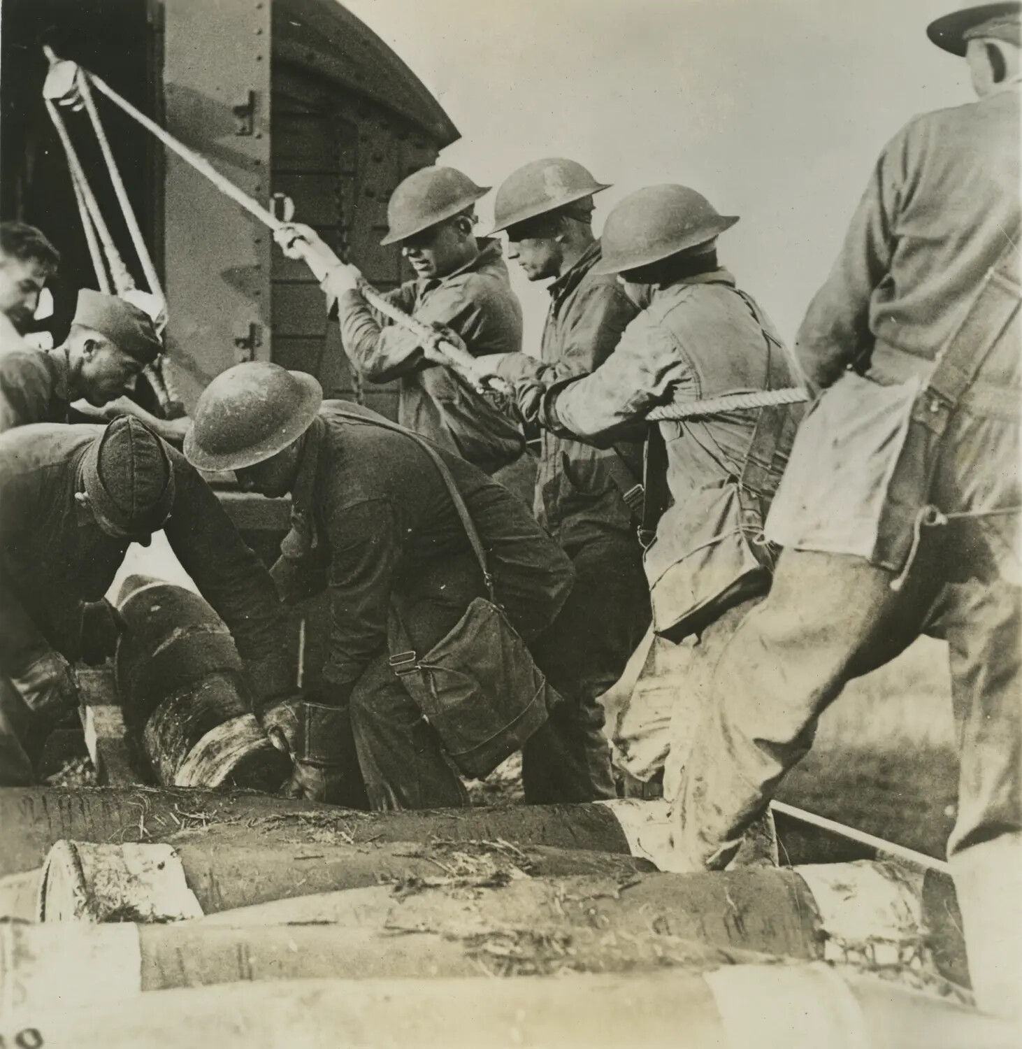 Soldiers Unloading Timber from a Railway Boxcar Using Rope and Pulley
