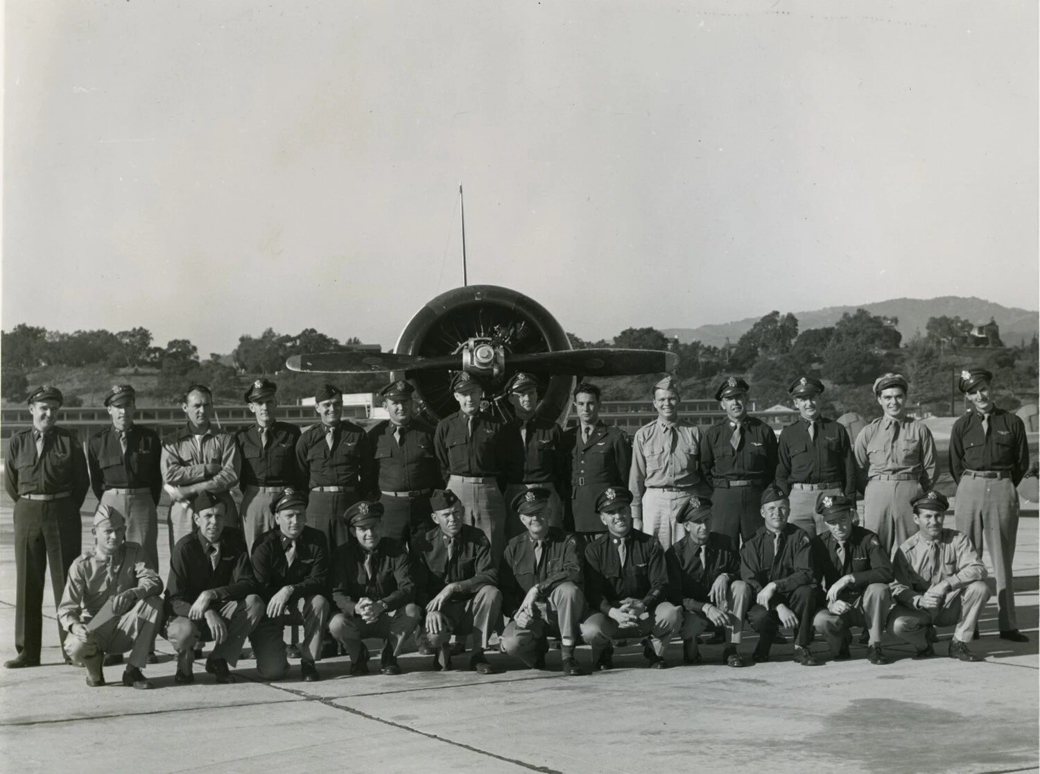 Squadron Group Portrait in Front of Radial-Engine Aircraft, WWII-Era Training Base