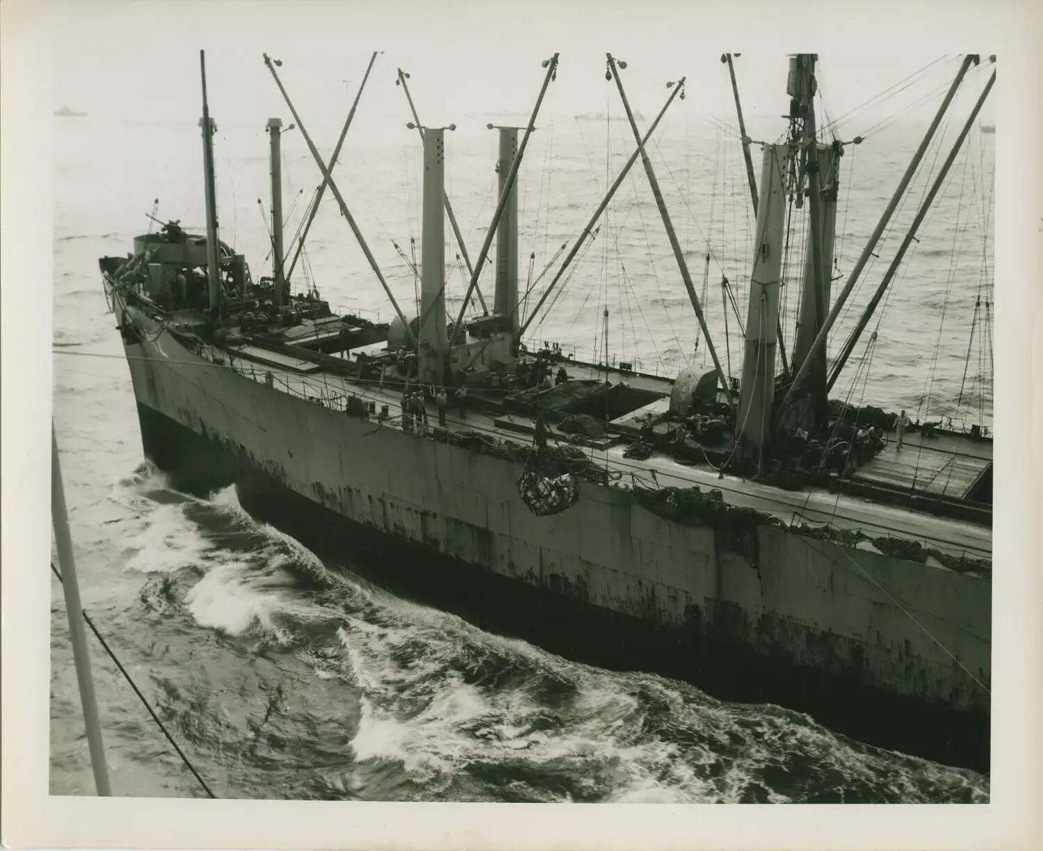 Underway Replenishment at Sea: U.S. Navy Cargo/Stores Ship Alongside, WWII Pacific Theater