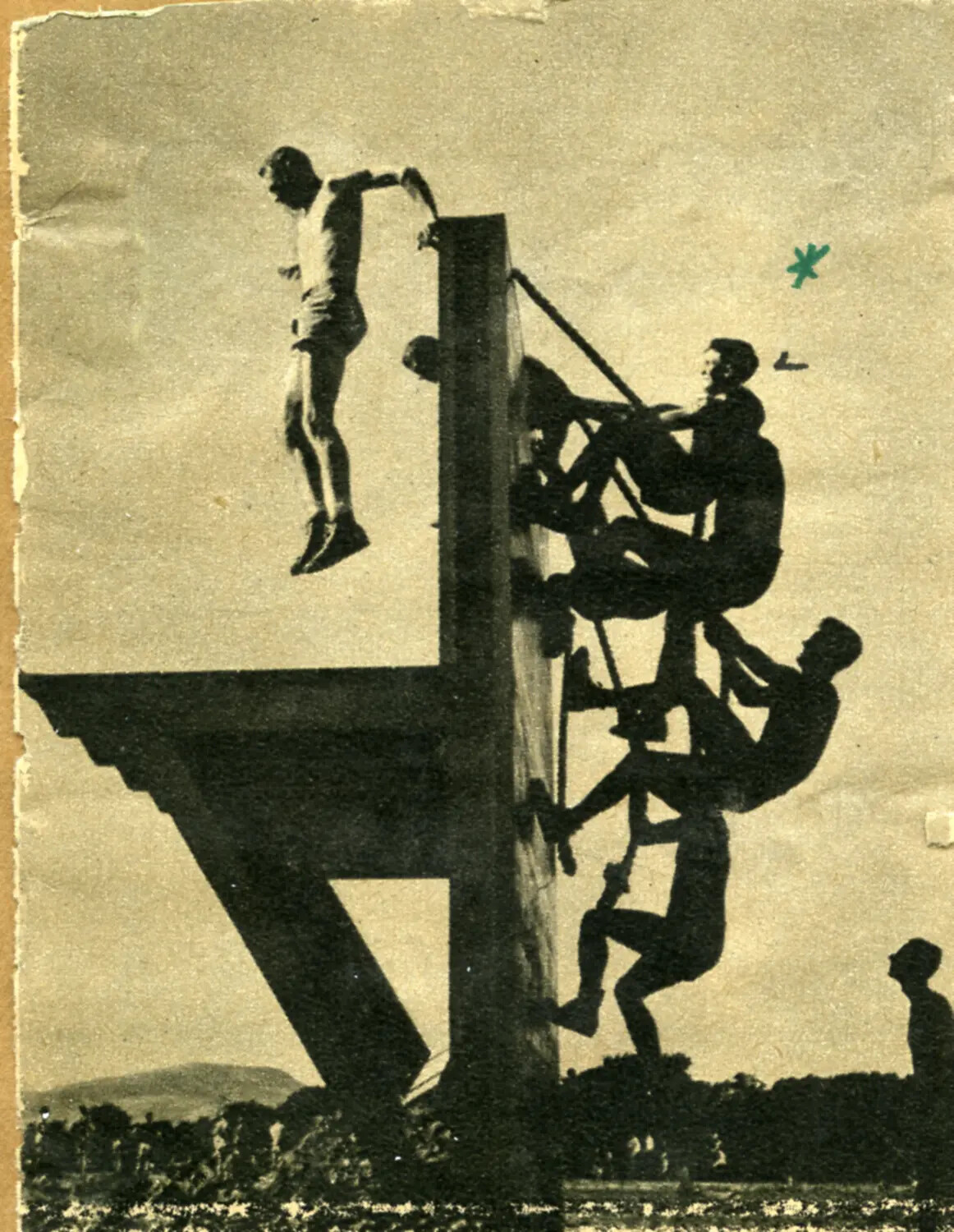 Newspaper/Magazine Clipping: Servicemen Climbing a Training Tower