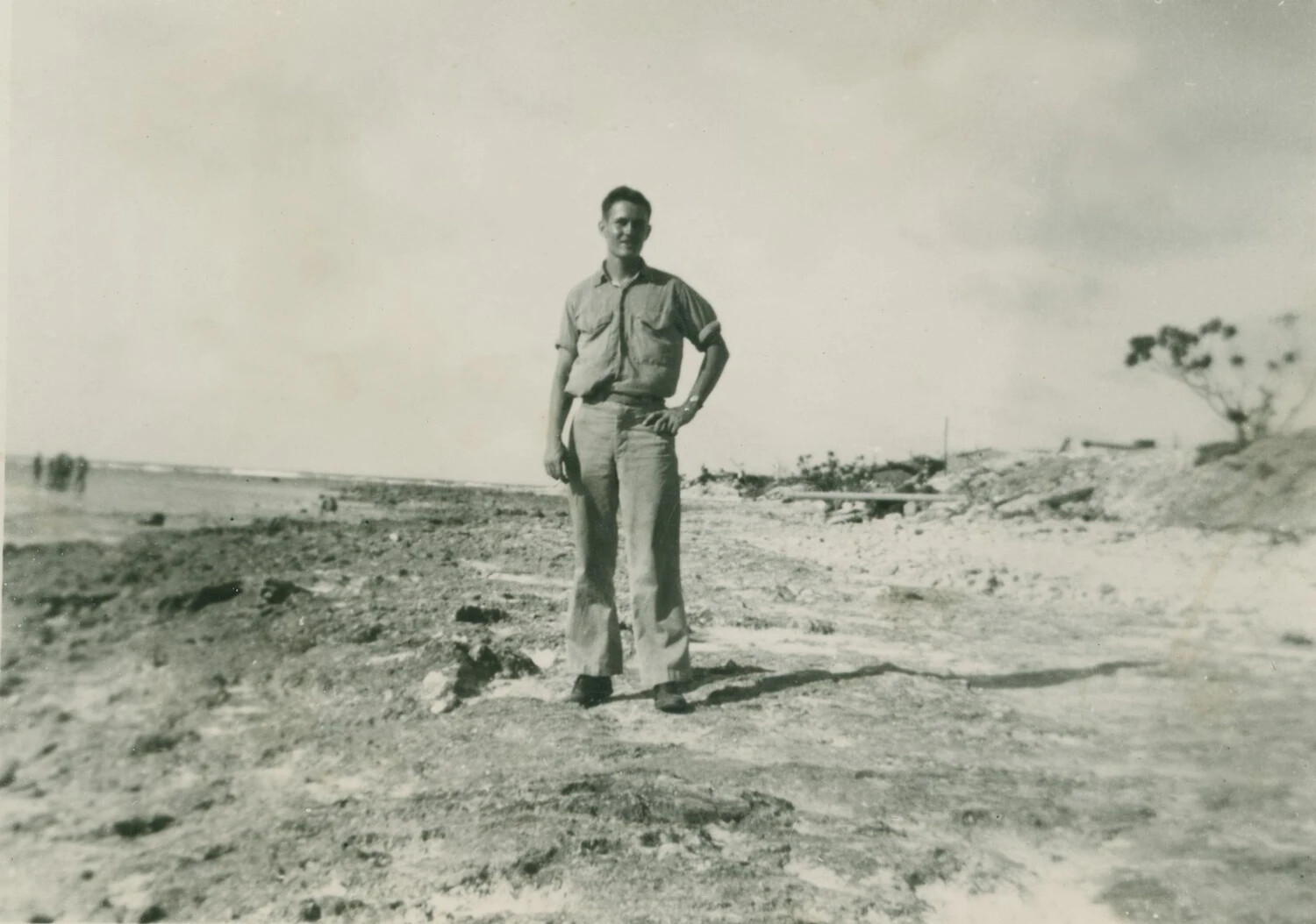 Serviceman on a Pacific Island Beach Amid War Debris