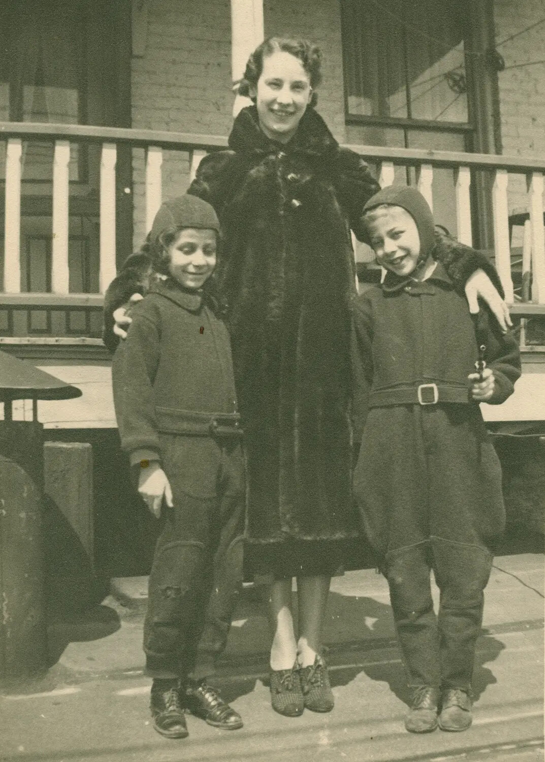 Family Portrait: Woman with Two Boys in Aviator-Style Winter Caps on Porch, c. 1930s–1940s