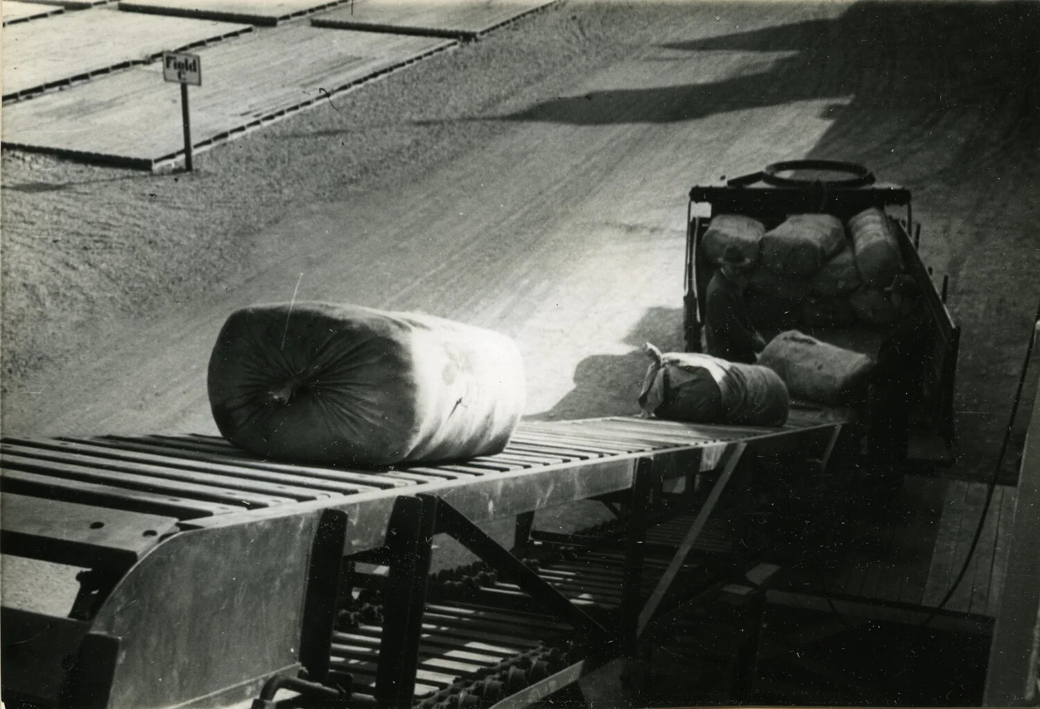 Roller Conveyor Unloading Baled Goods from Truck, Storage Field 'C', Supply Depot, Germany (Full-Frame Print)