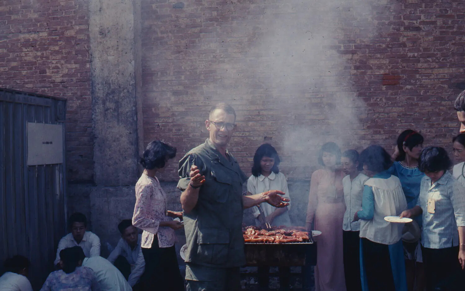 American Serviceman Grilling Food for Vietnamese Civilians, Tet 1968, Vietnam War