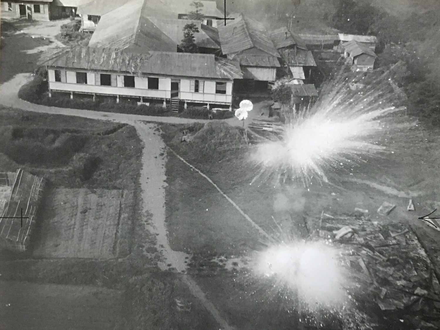 Strike Photograph of Bomb Detonations Near Barracks Complex, 312th Bomb Group Low-Level Attack