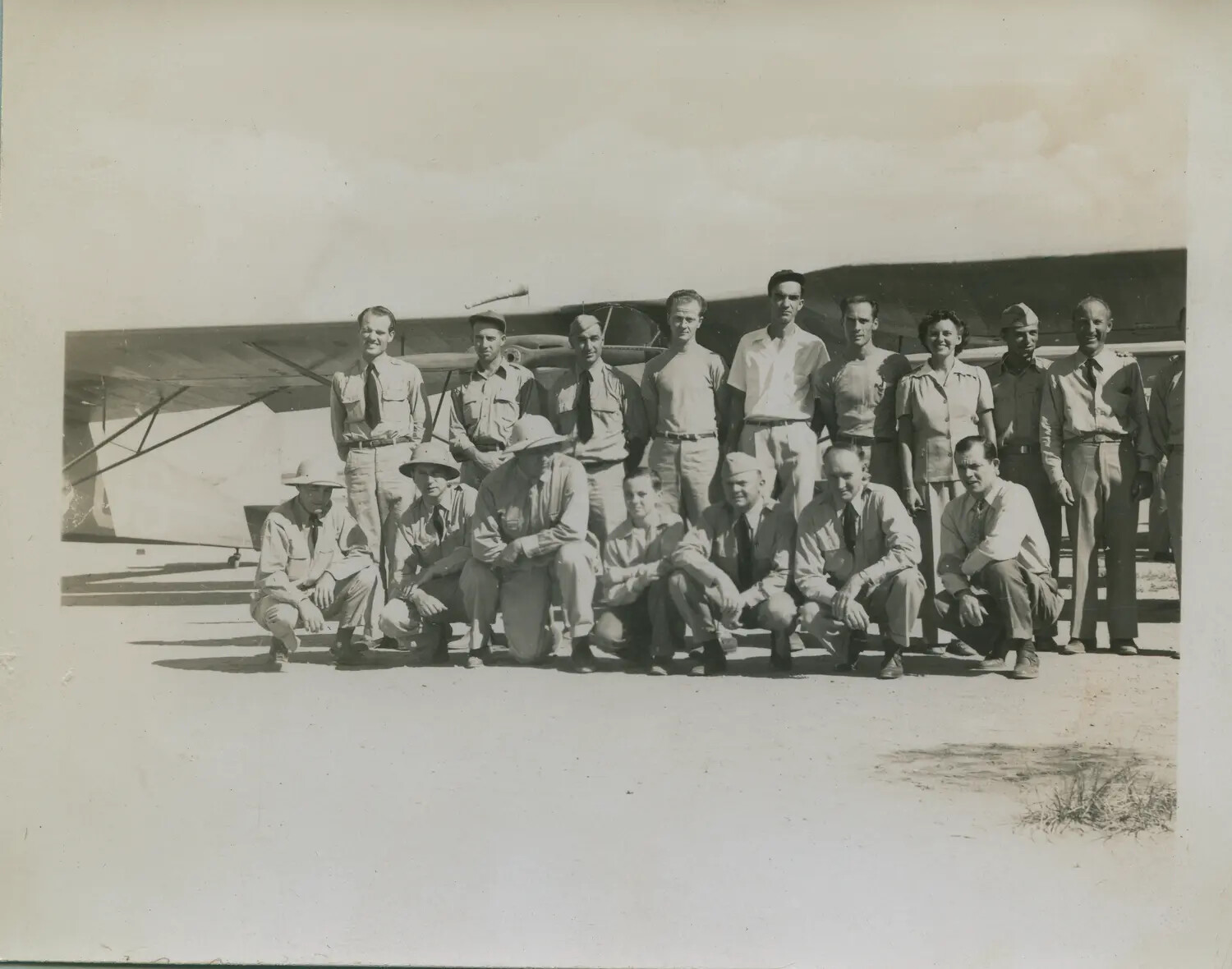 Group Portrait of Aviation Personnel Beside Aircraft Wing, Mid-20th Century