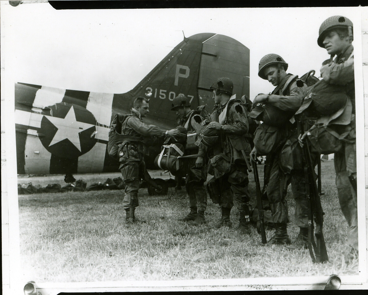 101st Airborne Paratroopers Making Final Equipment Checks Beside C-47 Transport Aircraft Before a Combat Jump, 1944