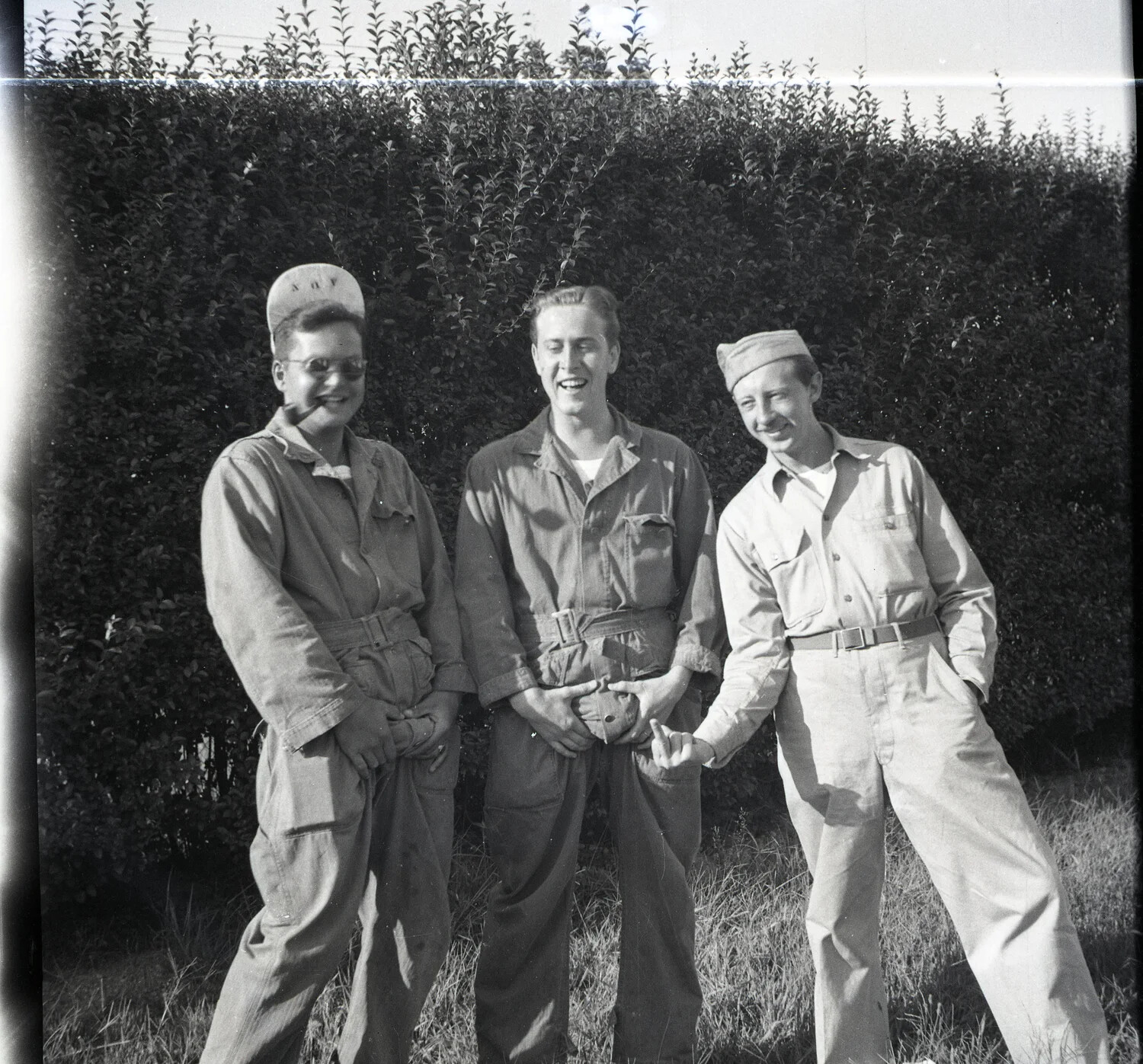 Three Servicemen in Coveralls and Work Uniforms Outdoors