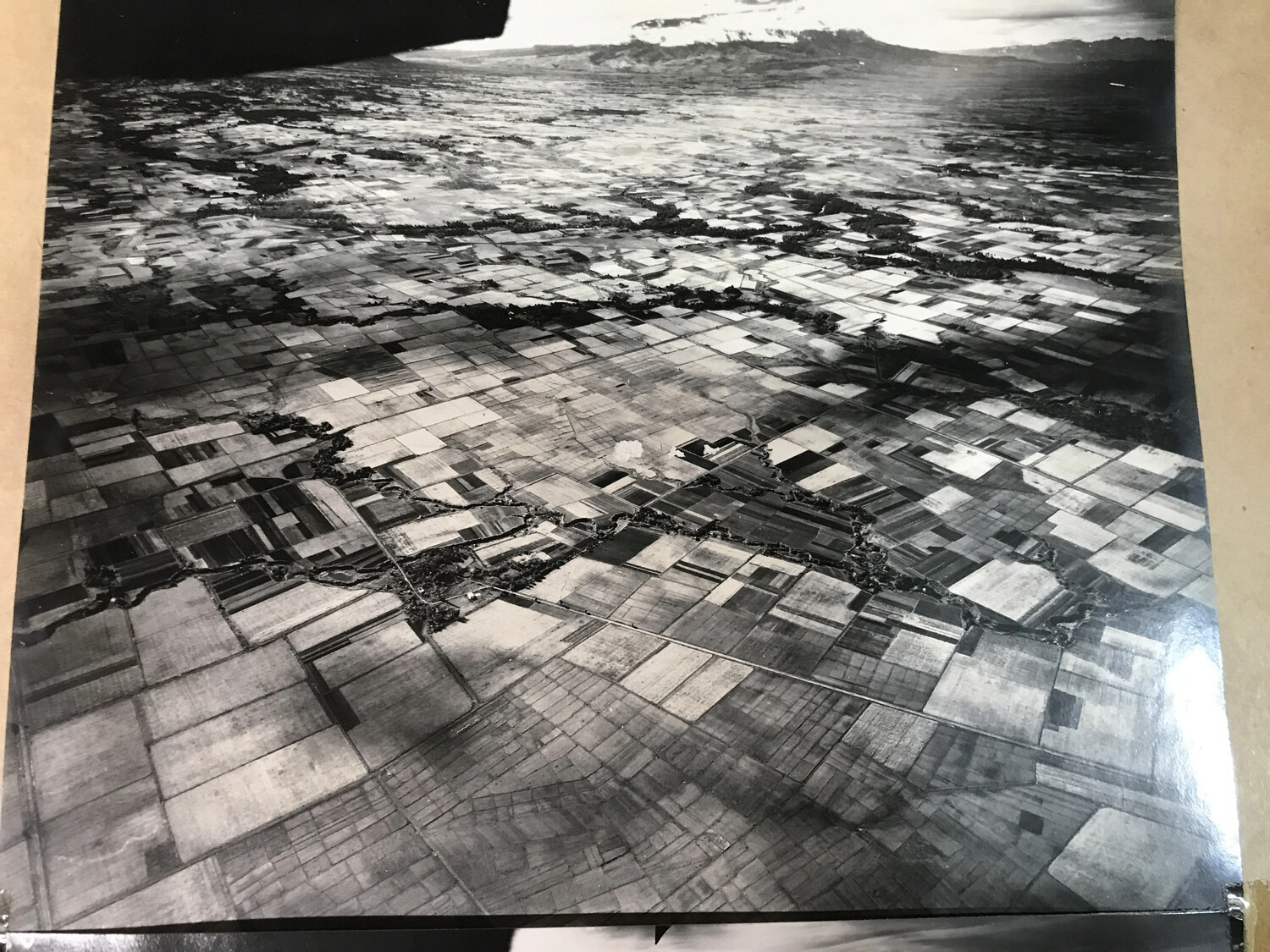 Full-Frame Aerial Photograph of Agricultural Terrain with Bomb Strike and Distant Mountain, Pacific Theater, WWII