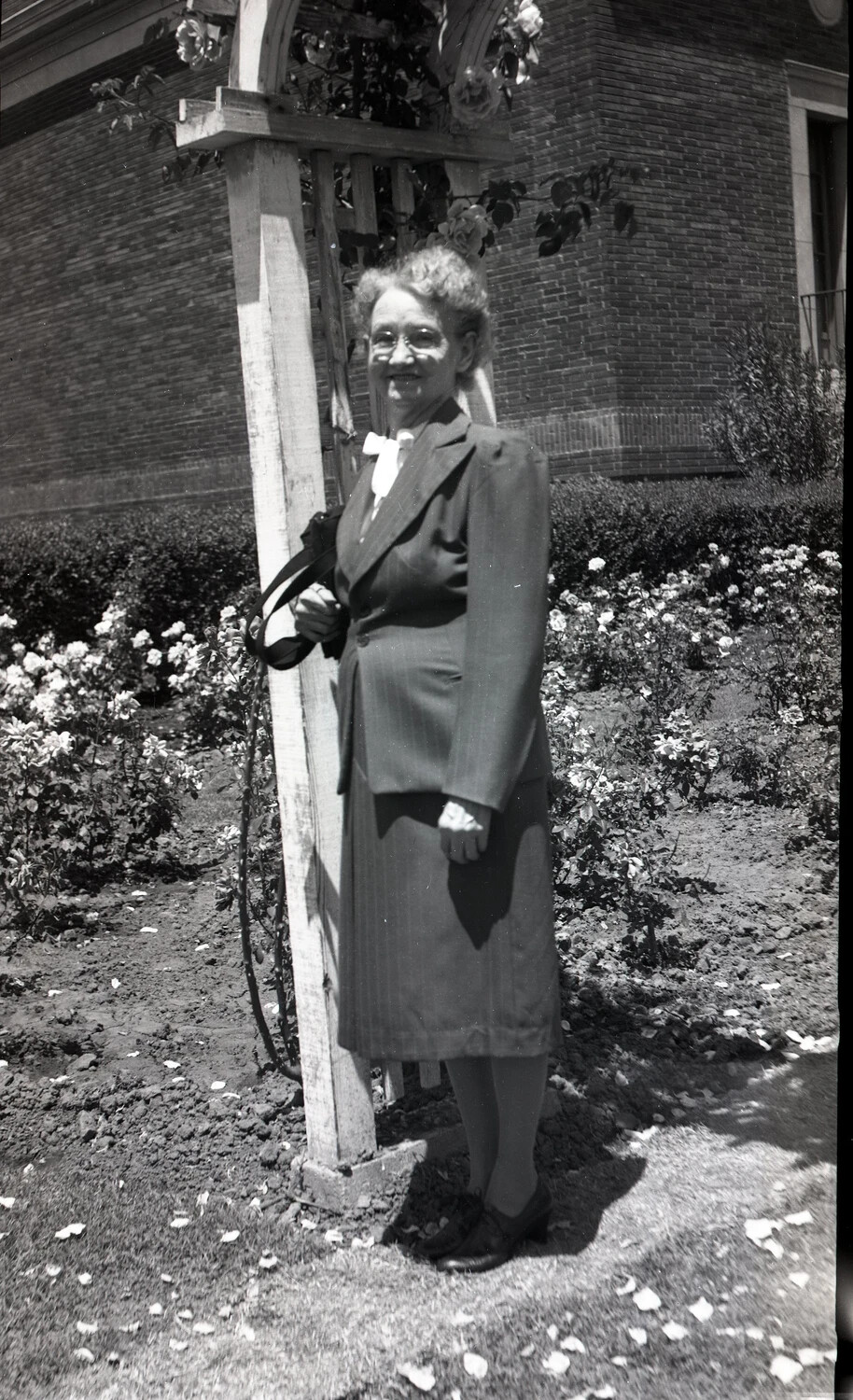 Elderly Woman in Rose Garden Beside Trellis, Kelley Family Album
