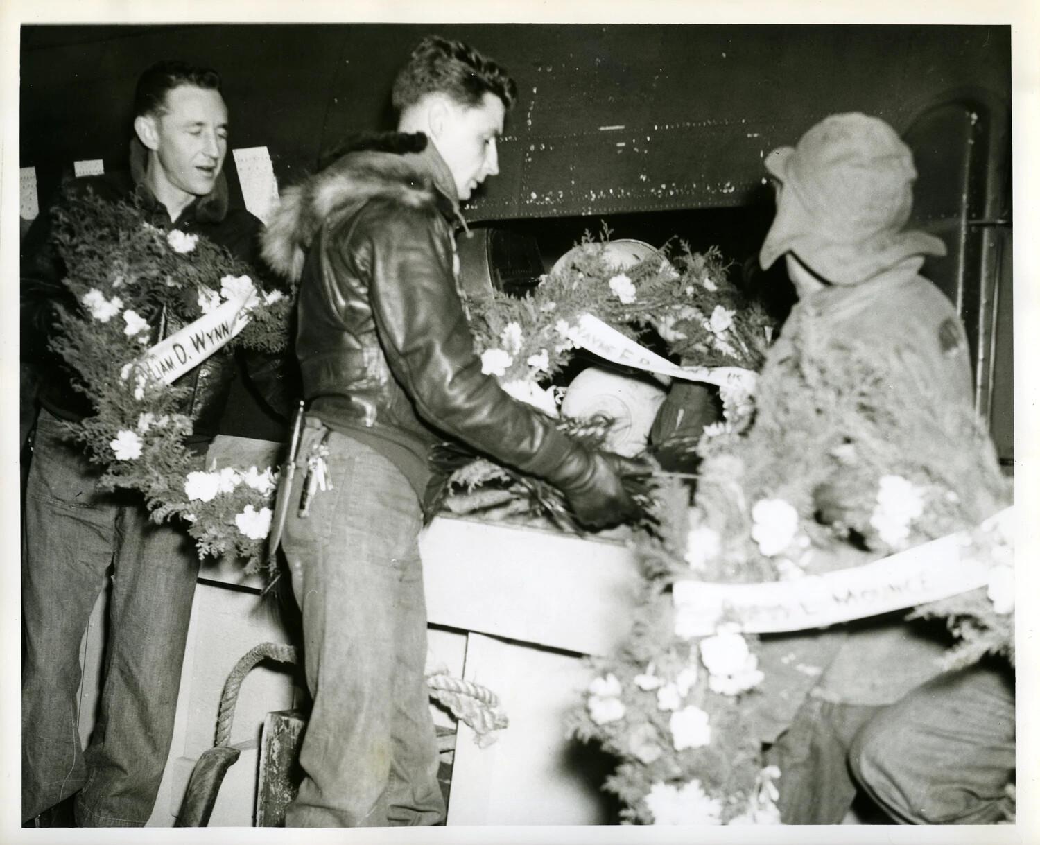 Servicemen with Named Memorial Wreaths Aboard Military Aircraft, Korean War Era