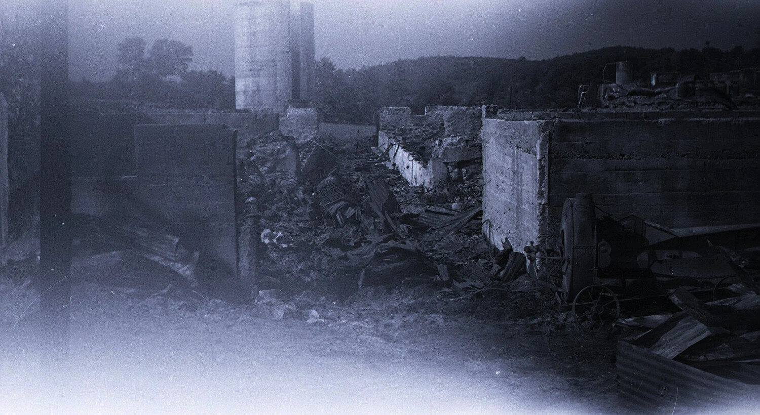Silo Foundations and Collapsed Machinery Amid Dairy Barn Fire Wreckage, Rural New England, c. 1940s