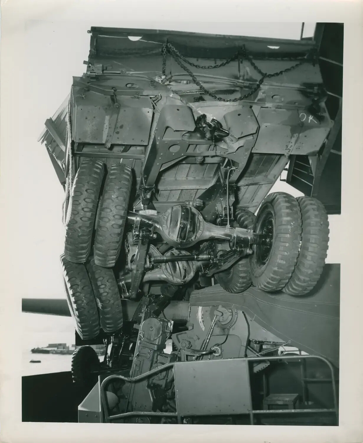 Truck Hoisted by Crane Aboard/Alongside USS Petrof Bay (CVE-80), WWII