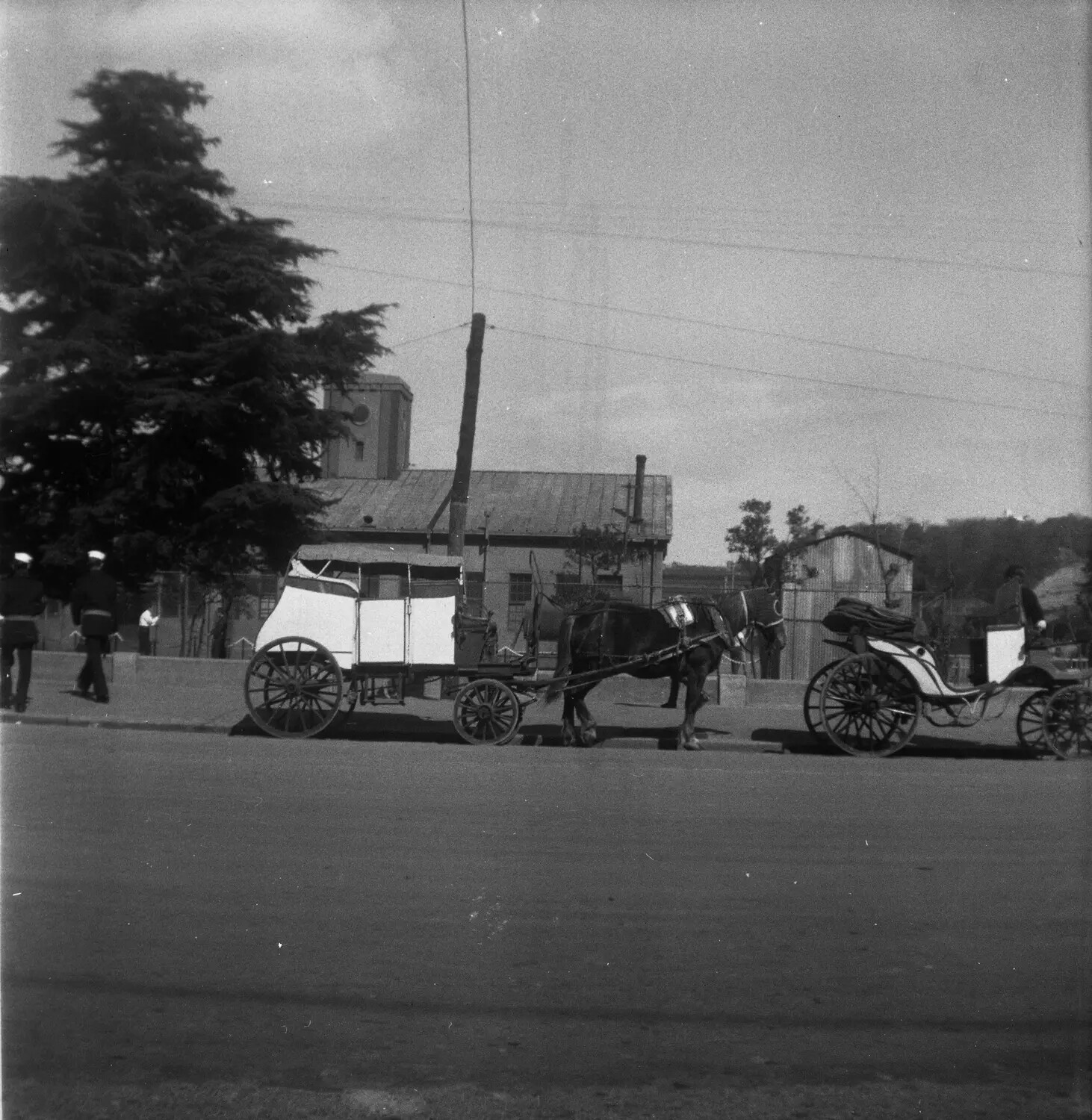 Horse-Drawn Carriages and U.S. Navy Sailors on Street in Sasebo, Japan, Post-WWII Occupation Era