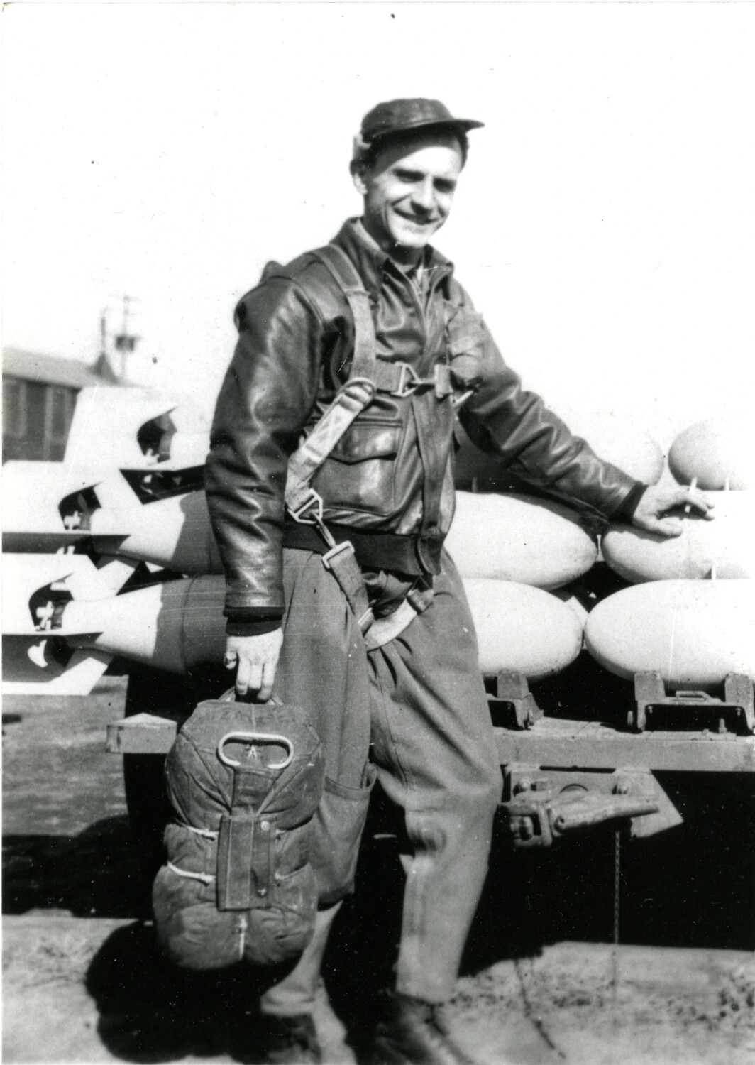 Airman Posing with Ordnance and Parachute Gear, 345th Bomber Group Area, WWII Pacific Theater