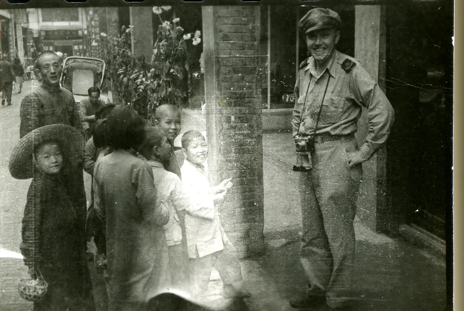 American Serviceman with Local Children on a Street in the China-Burma-India Theater, WWII