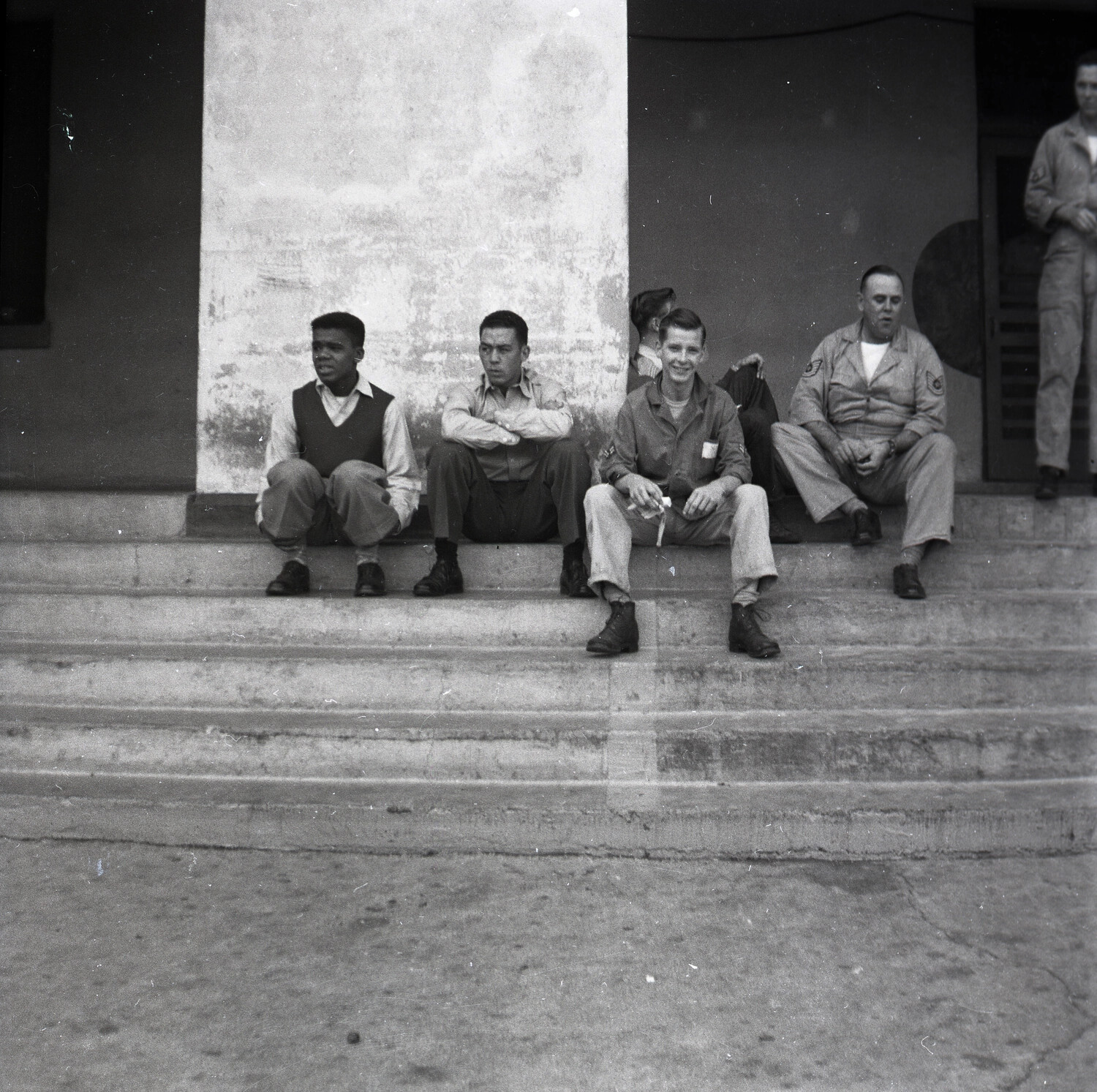Group of Airmen Seated on Barracks Steps, USAF Base, 1950s