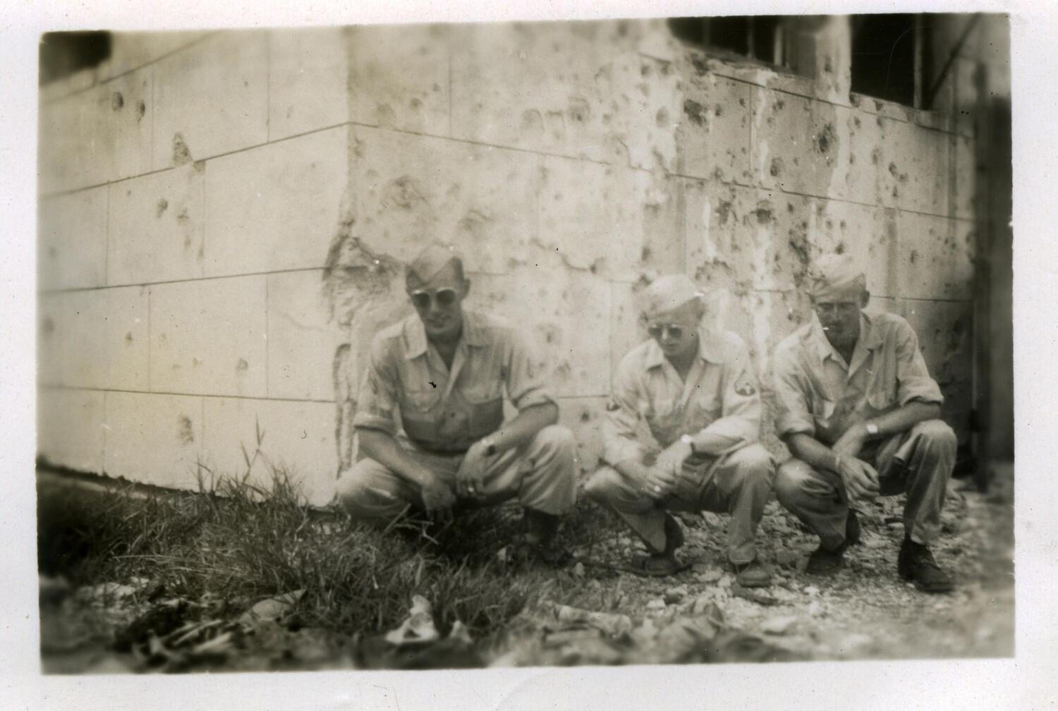 Servicemen Beside Bullet-Scarred Wall, Battle of Okinawa, World War II