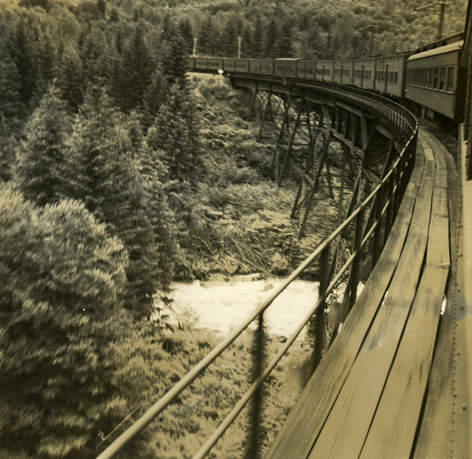 Passenger Train Crossing Mountain Trestle Near Whitefish, Montana