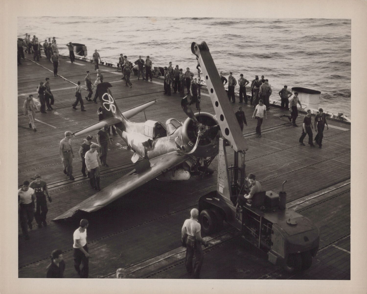 Damaged Carrier Fighter Aircraft Being Cleared from Flight Deck, USS Petrof Bay (CVE-80)