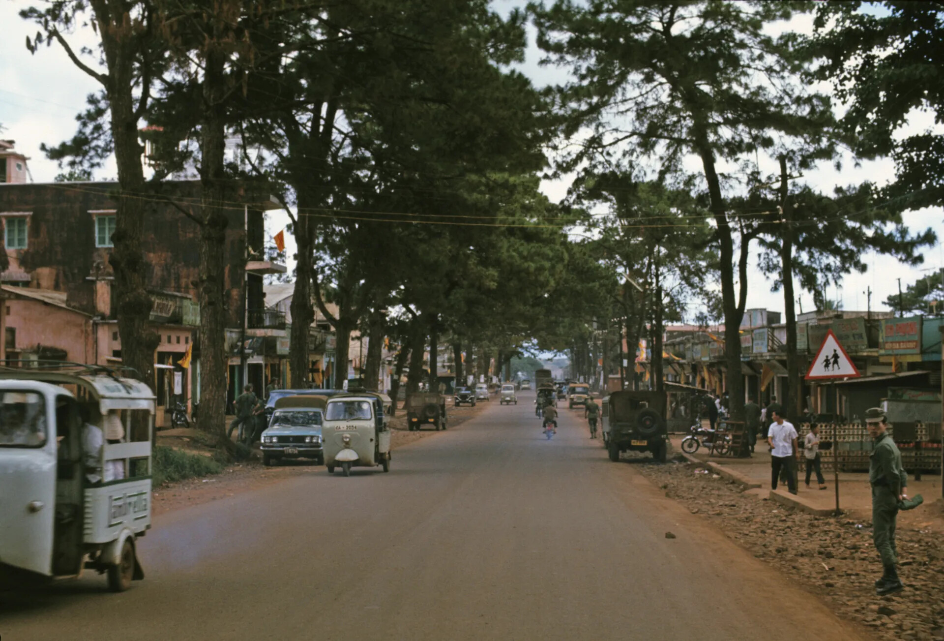 Tree-Lined Main Street with Civilian and Military Traffic, South Vietnamese Town, circa December 1969