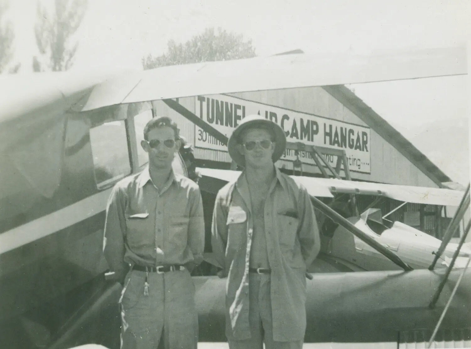 Two Men with Light Aircraft at Tunnel Air Camp Hangar - McAleer Collection, Postwar Era