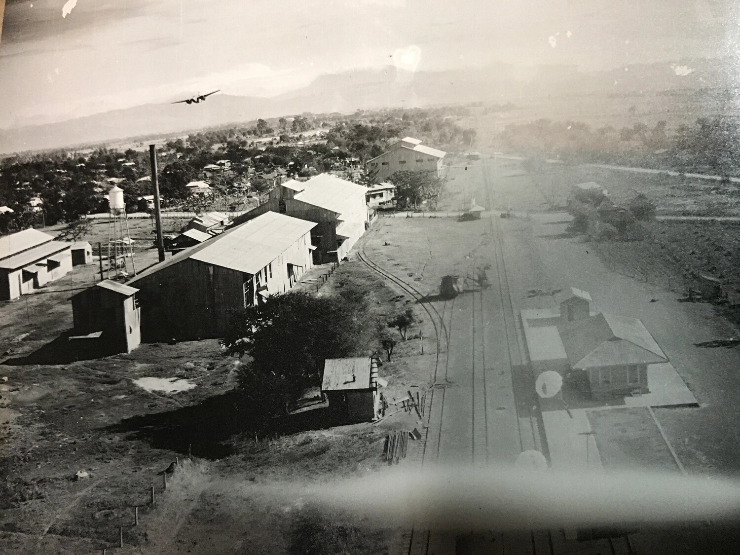 B-25 Mitchell Overflying Rail Yard and Industrial Buildings, Philippines
