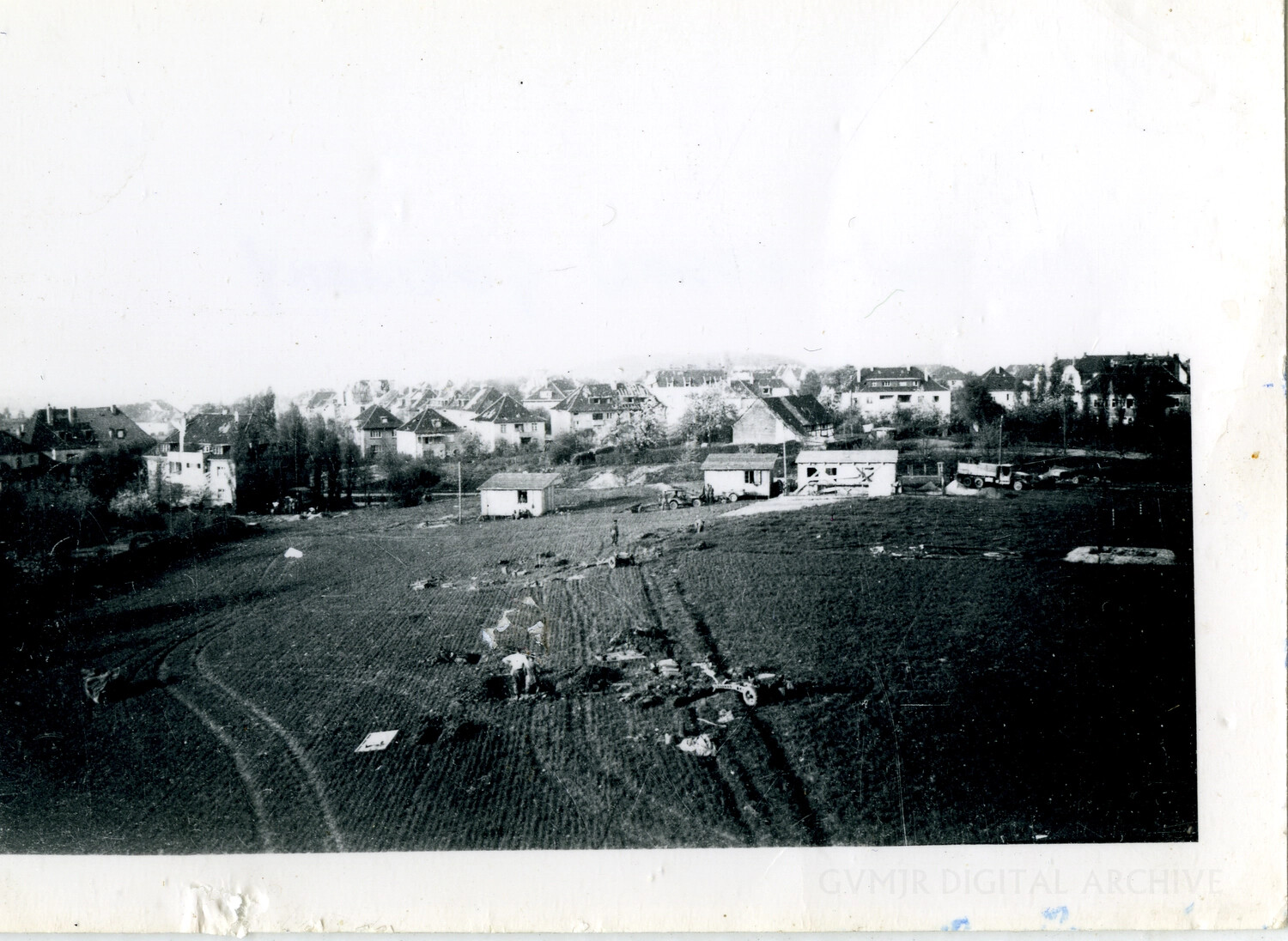 Aerial View of a Field Crash Site or Wreckage Recovery Operation Near a European Town