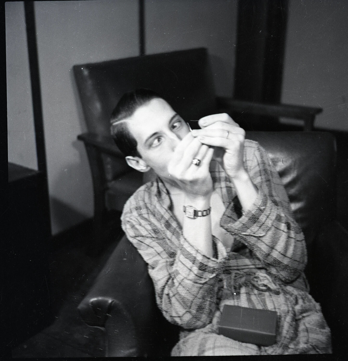 Candid Portrait of a Young Man Grooming in Plaid Robe