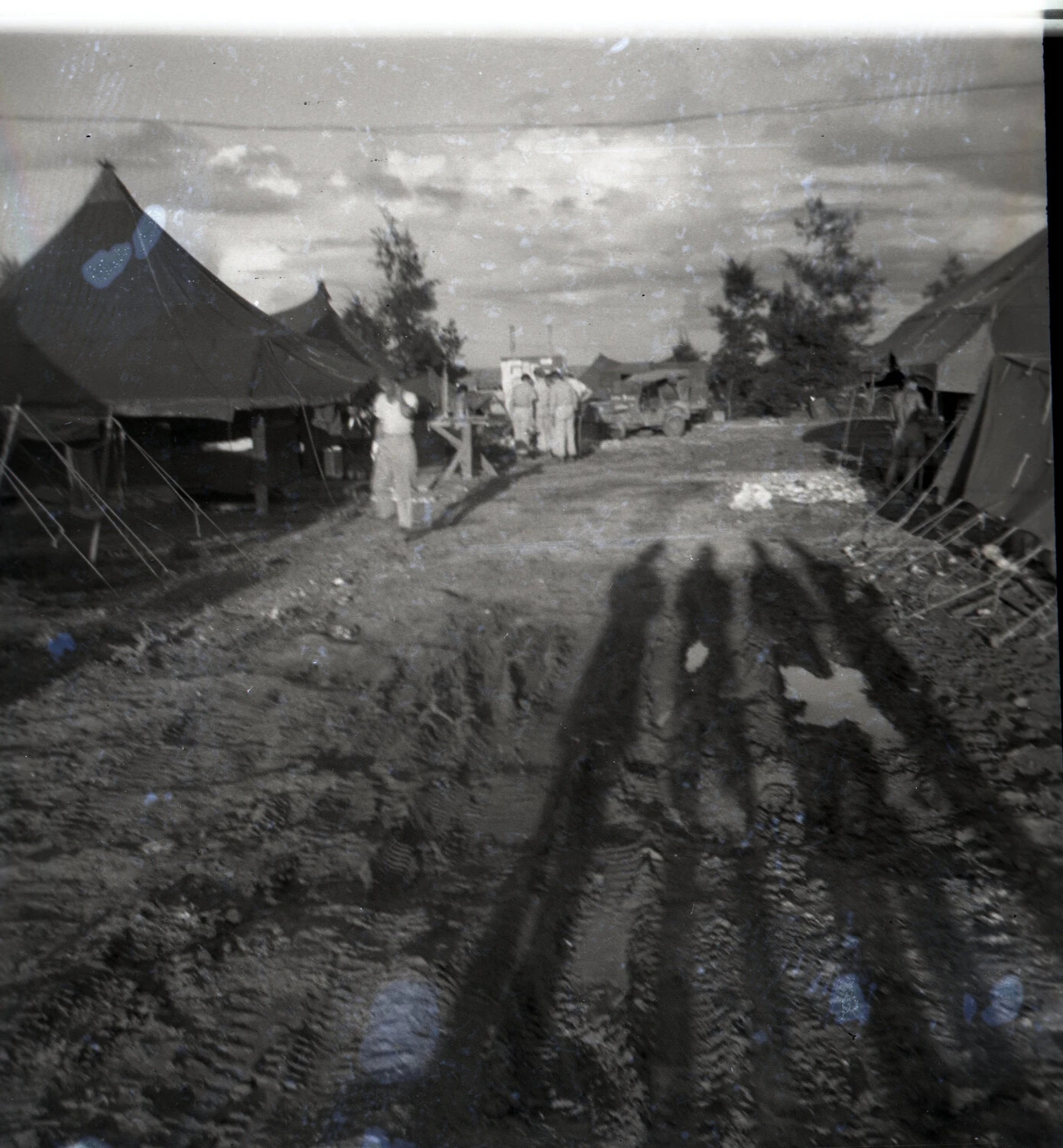Muddy Camp Road Between Tent Rows with Long Shadows, Ie Shima, WWII Photo Album